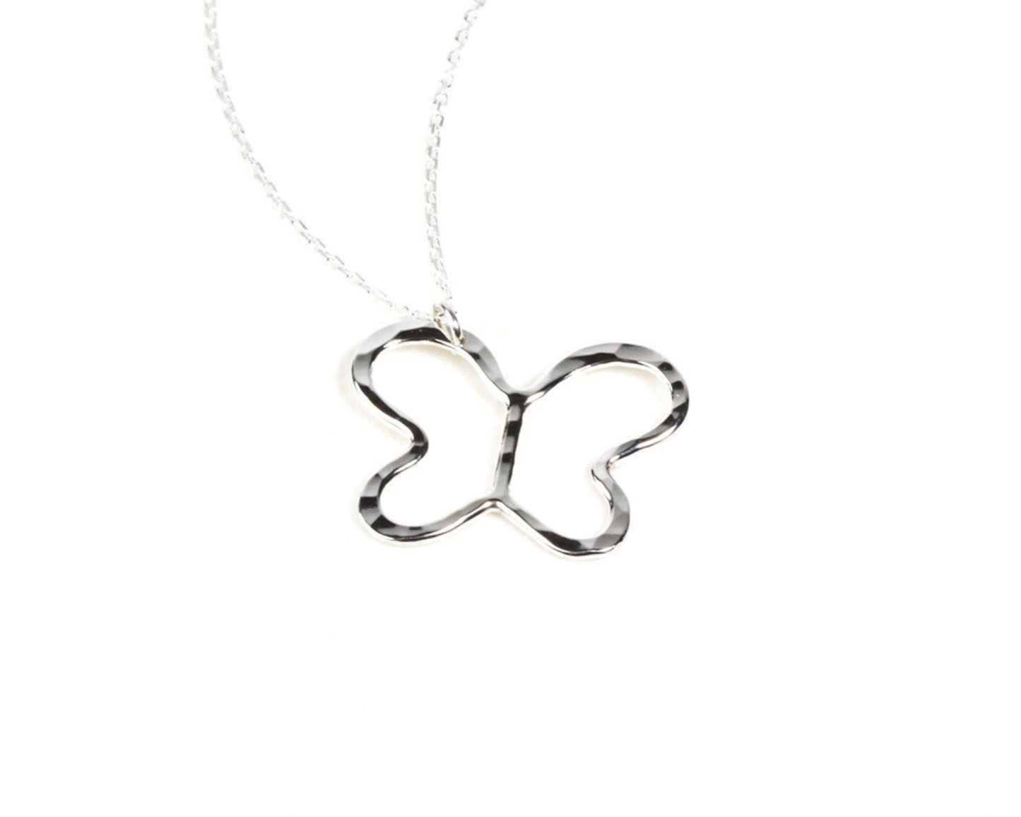 Enchanted Butterfly Necklace is hand made to order in fine metal, bringing the magic of the butterfly into every day. The minimalist butterfly pendant hangs from a single wing, giving it a playful tilt. Pictured here in Sterling Silver.