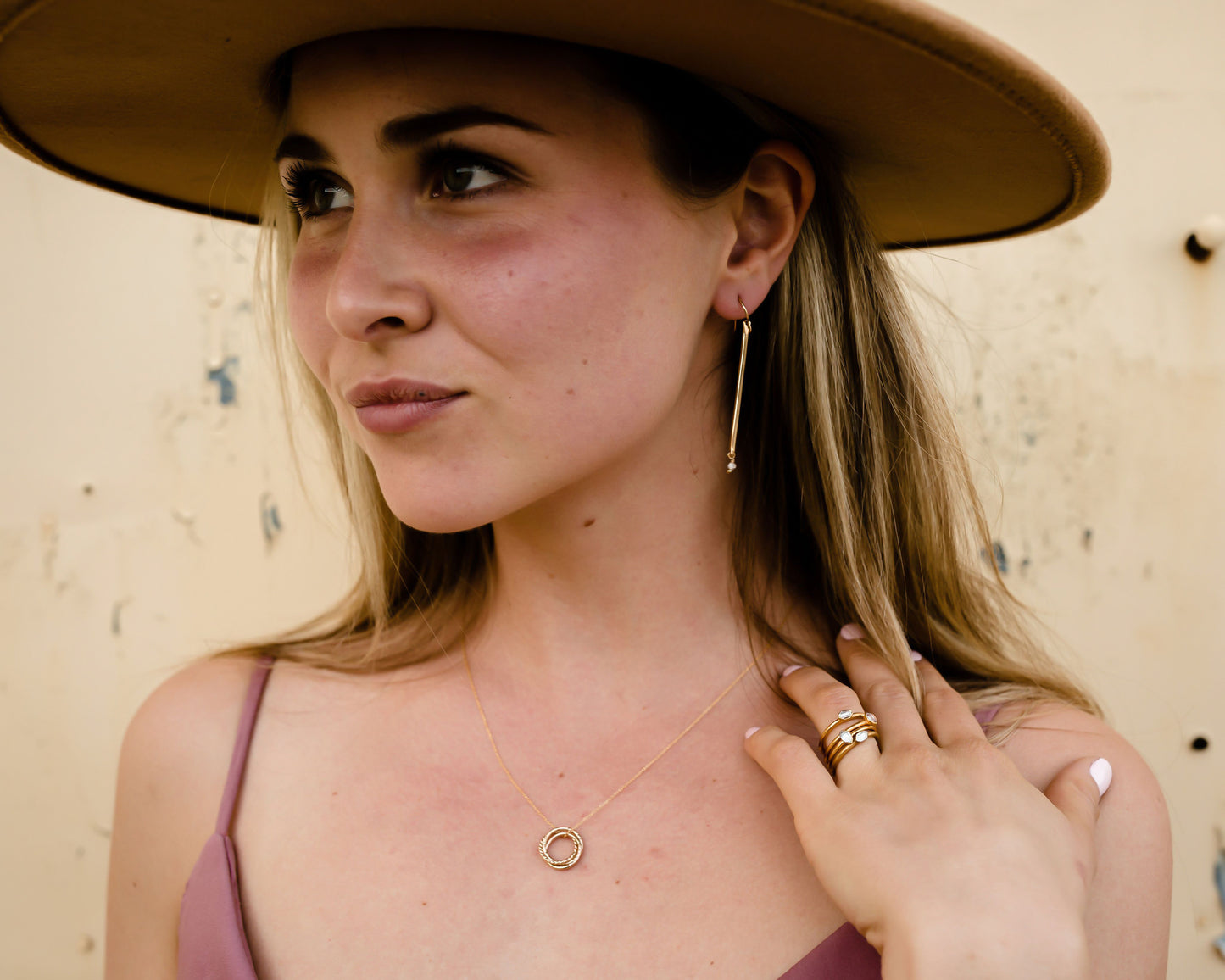 Model is showcasing the delicate bar earring personalized with birthstone in 14 karat gold filled. Handmade and handcrafted in fine metal, you select the stone to pair with your bar earrings for a truly custom pair of earrings. Great birthday gift.