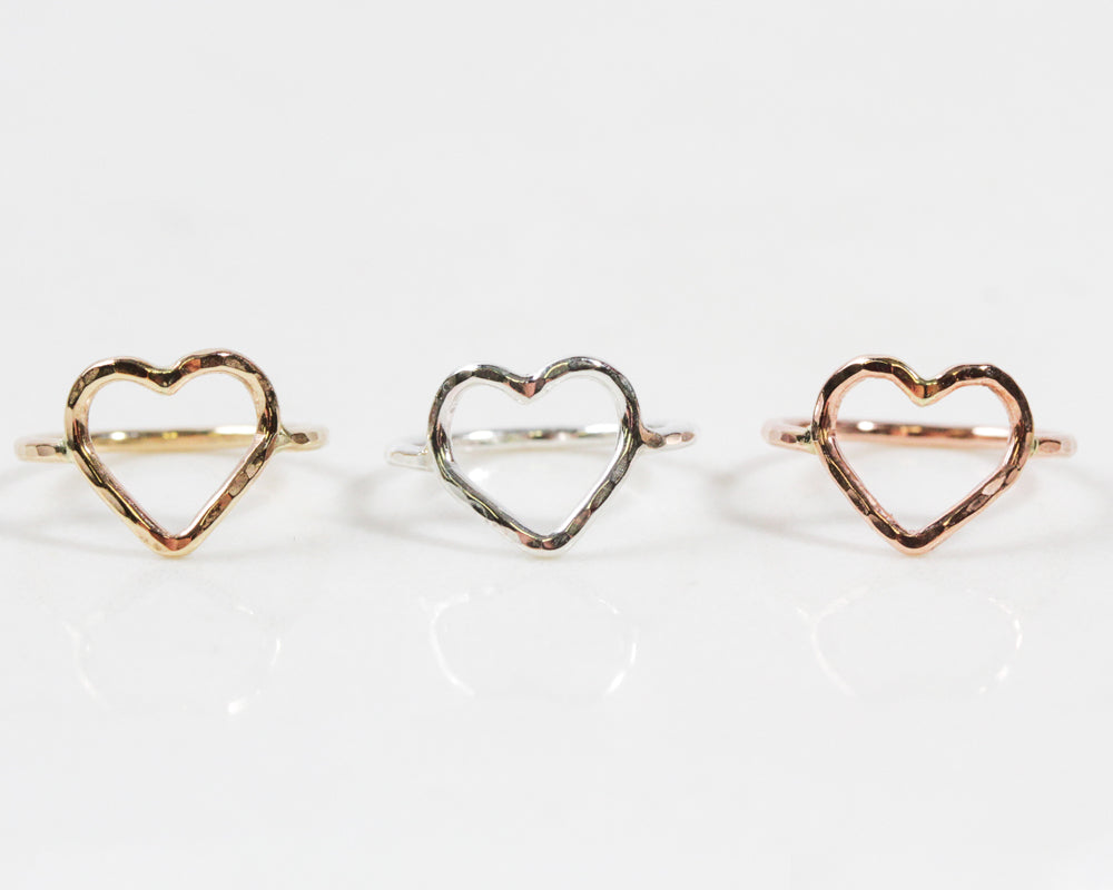 Image shows close up of all three fine metal selects of our Mini Heart Ring. Offered in Sterling Silver or Rose or Yellow Gold filled, this heart ring will steal hearts. Can be worn as a pinky ring, midi ring or a toe ring. Best Valentines Gift!