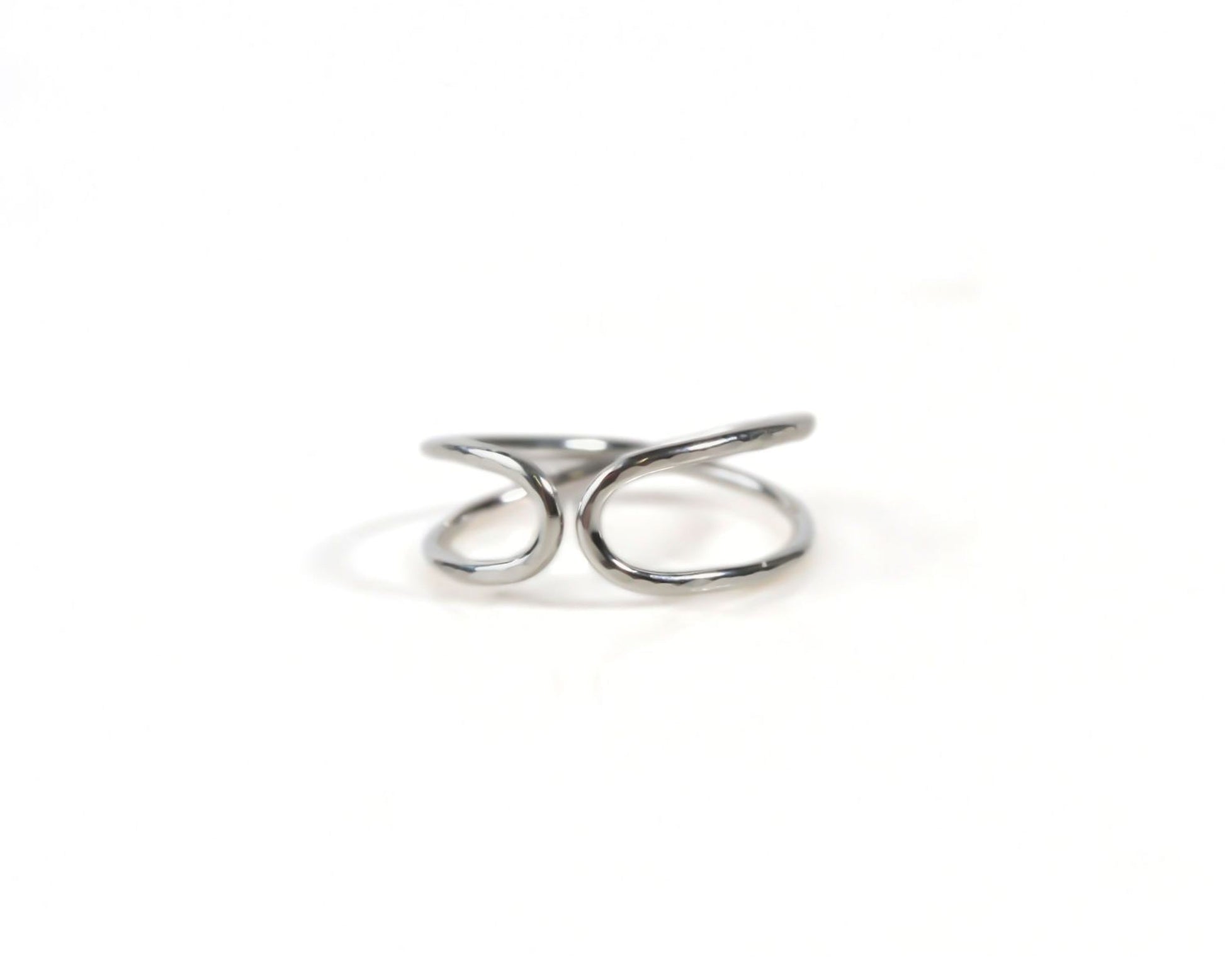 A silver ring with a twisted, coiled design.