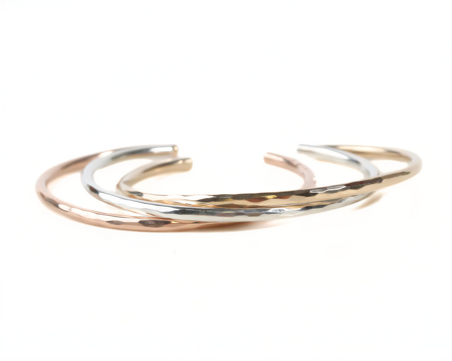 A group of three bracelets with different colors and textures, arranged in a circular pattern.