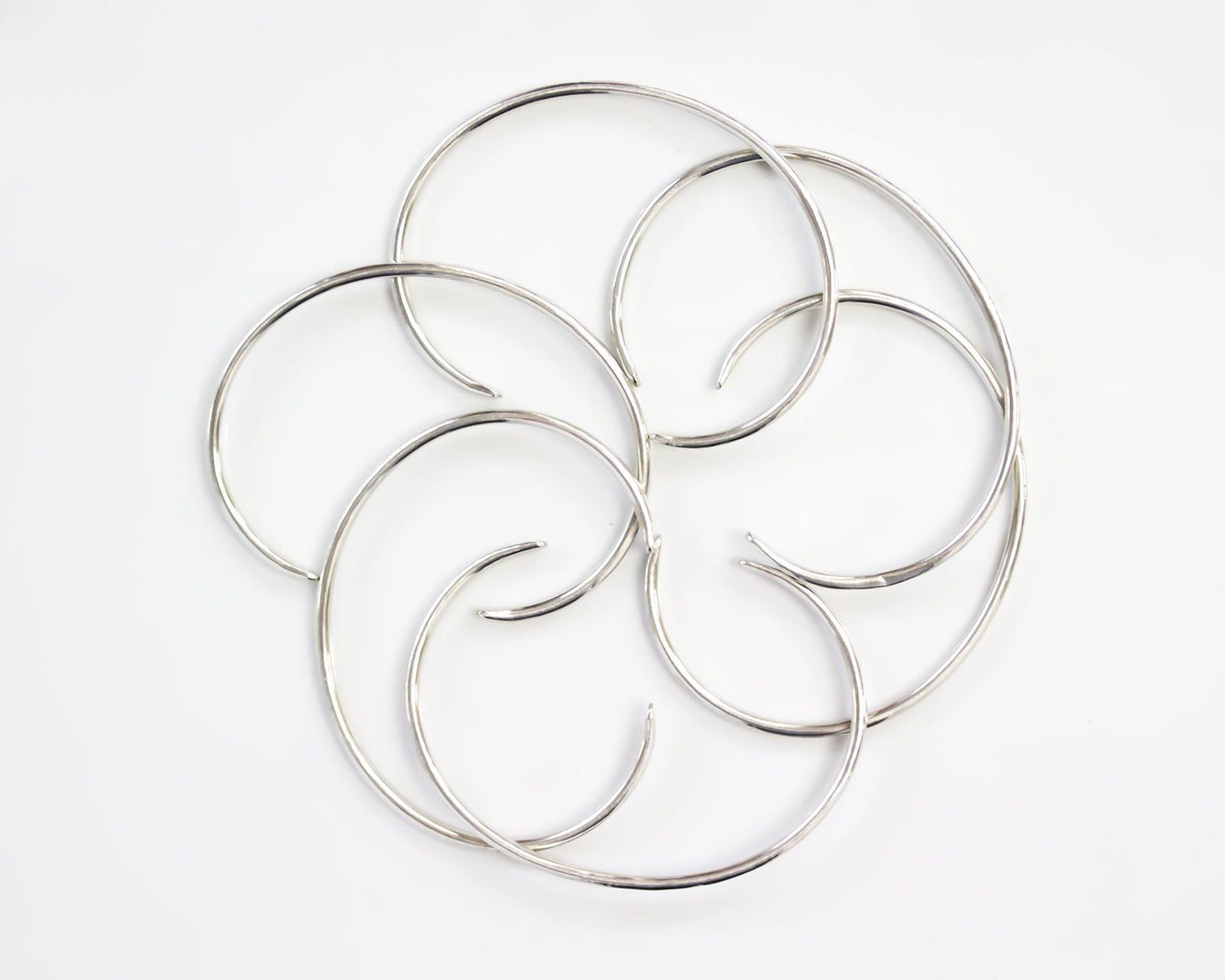 a circular arrangement of silver-colored metal rings or circles, creating a visually striking and intricate design.