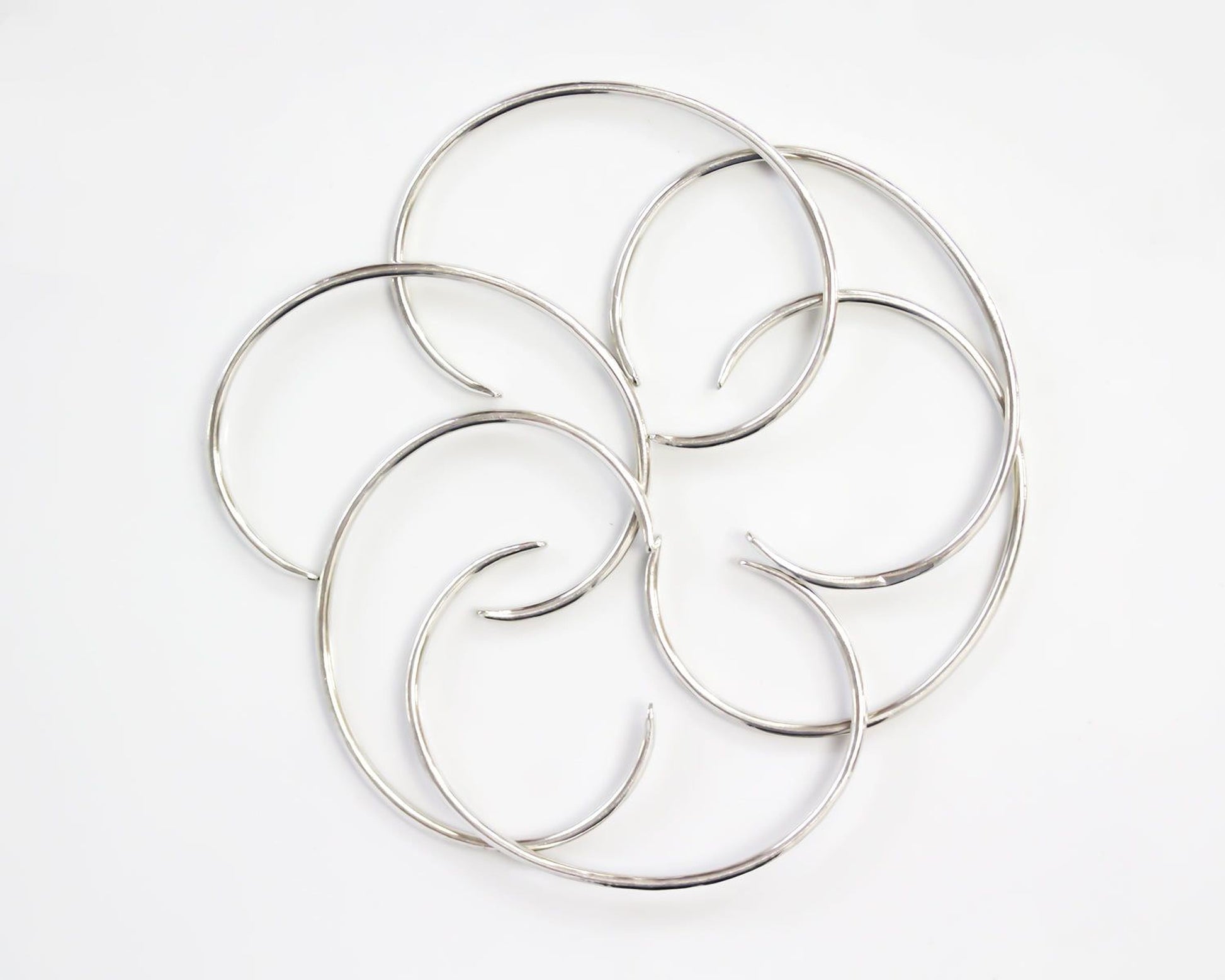 a circular arrangement of silver-colored metal rings or circles, creating a visually striking and intricate design.