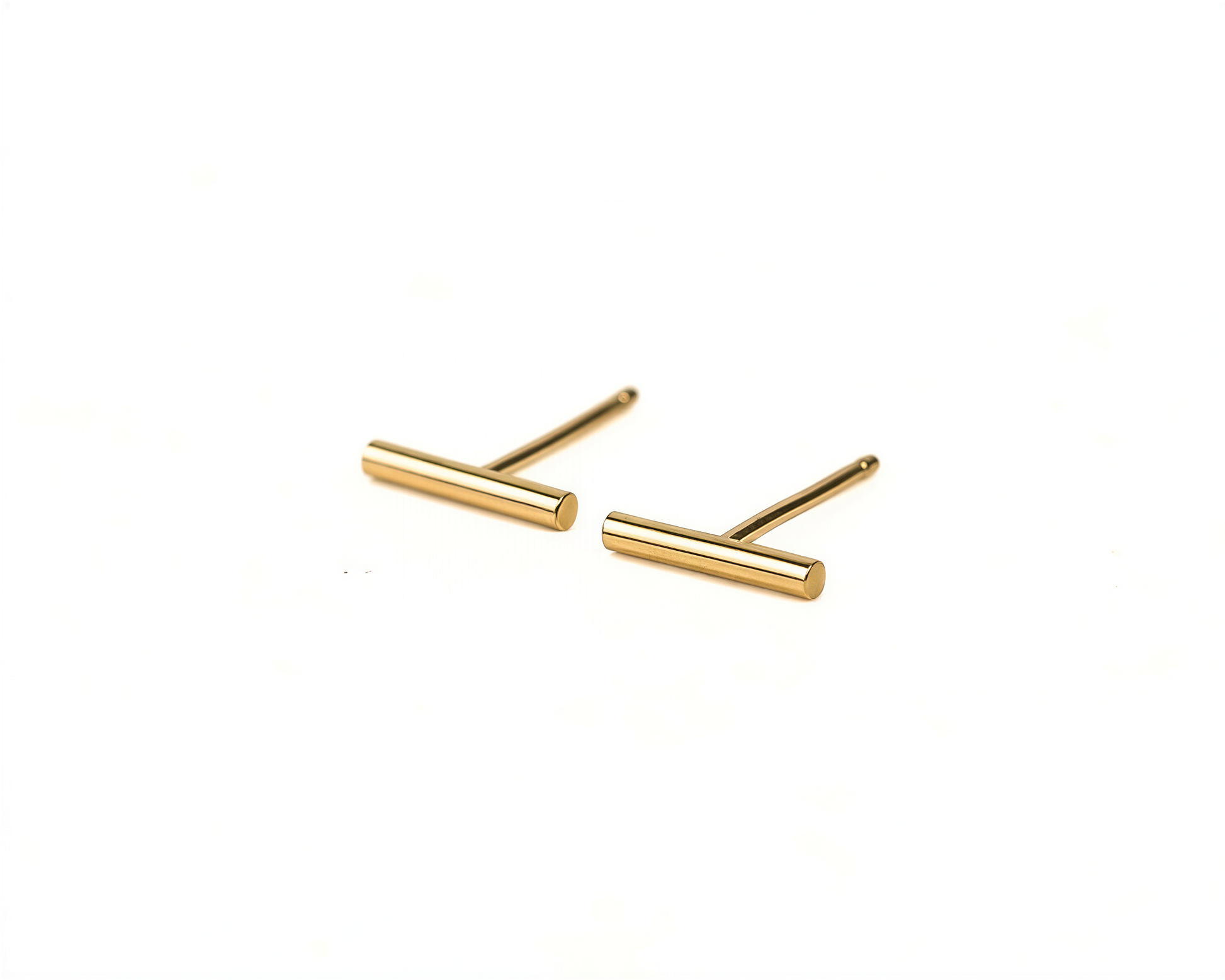 A pair of gold-colored earrings with a simple, minimalist design.