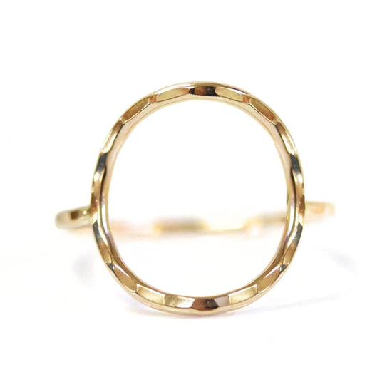 A gold ring with a unique, textured design.