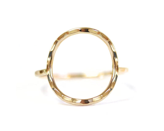 A gold ring with a unique, textured design.