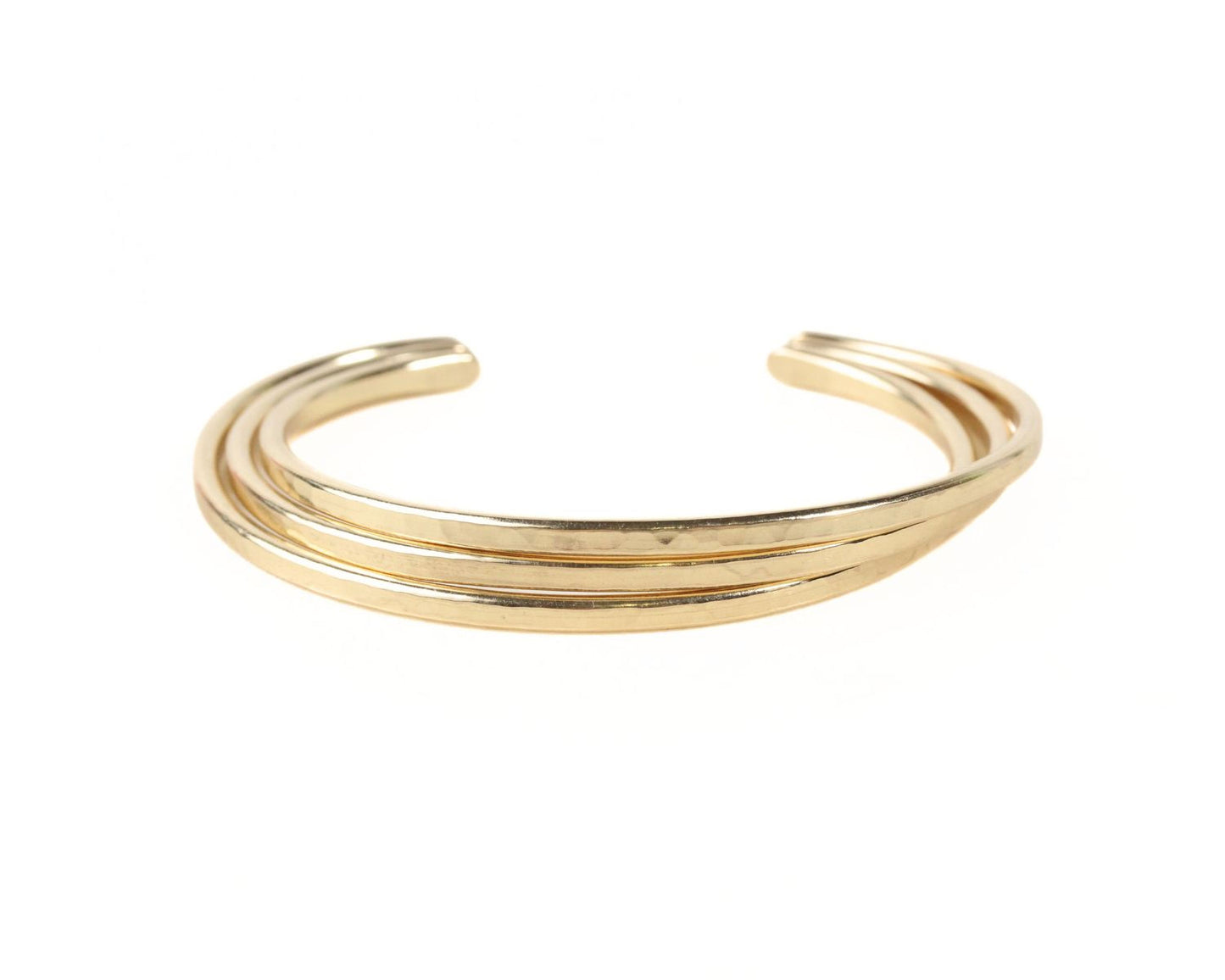 A gold-colored bracelet with three overlapping curved bands.