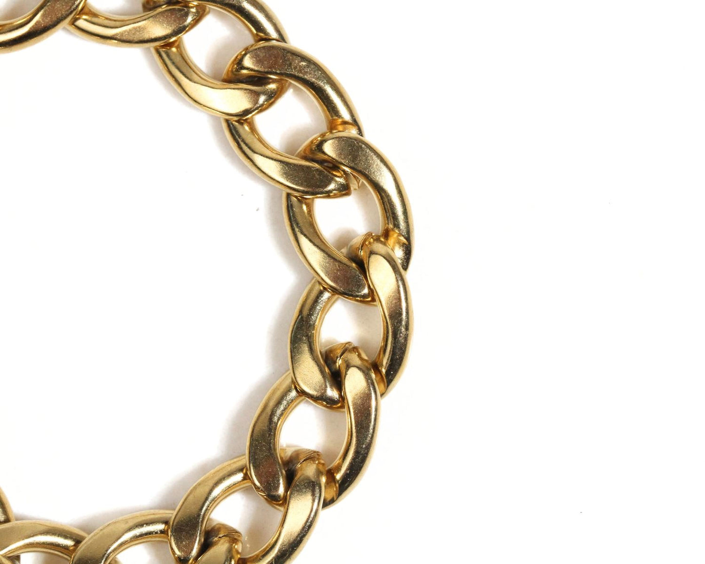 A close-up view of a gold-colored chain bracelet against a white background.