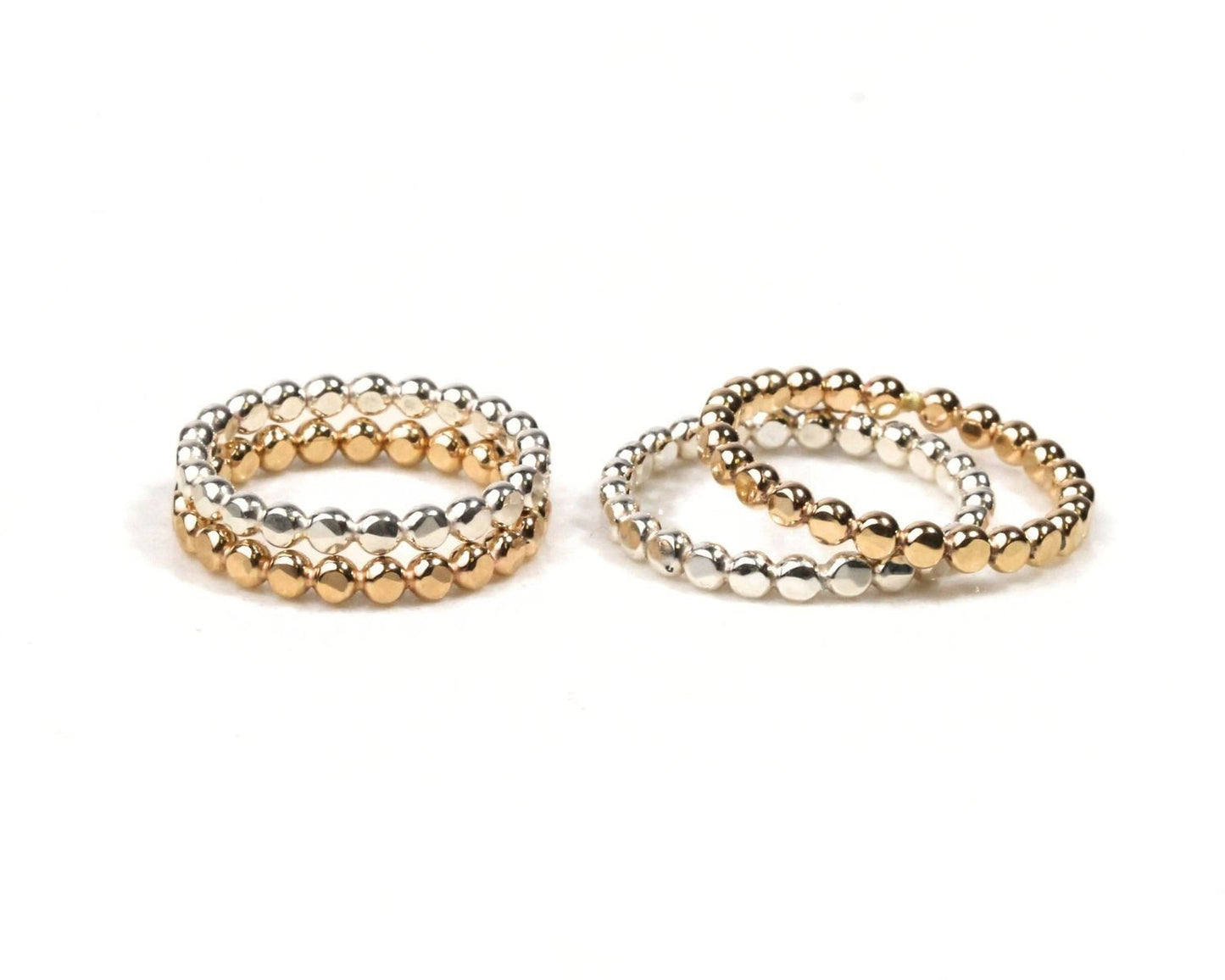 a collection of three beaded rings, each with a unique design and color, arranged side by side on a white background.