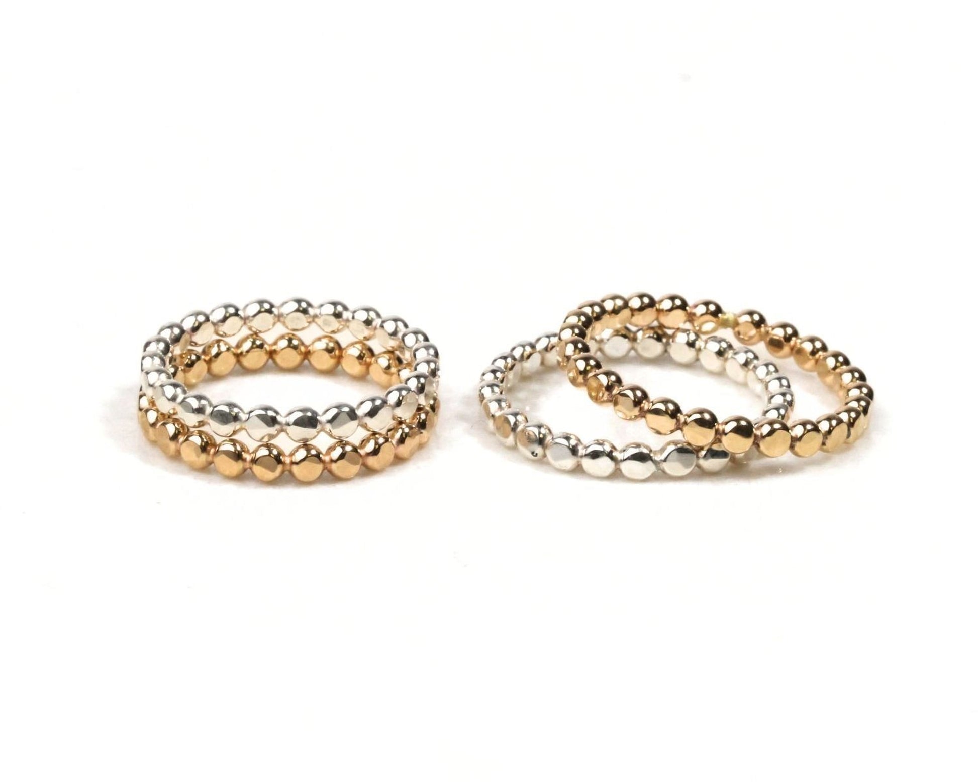a collection of three beaded rings, each with a unique design and color, arranged side by side on a white background.