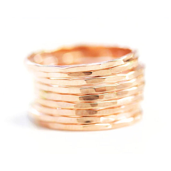A stack of gold-colored rings against a white background.