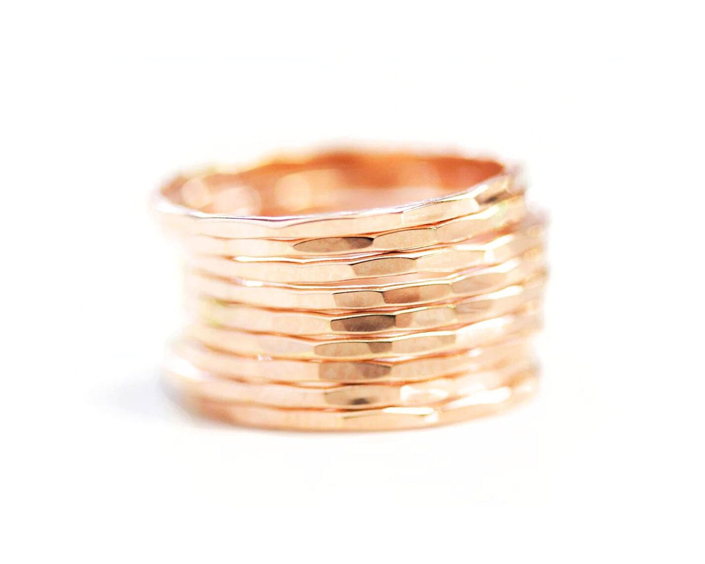 A stack of gold-colored rings against a white background.