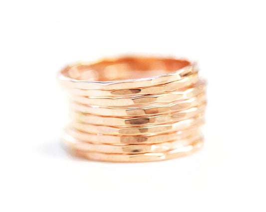 A stack of gold-colored rings against a white background.