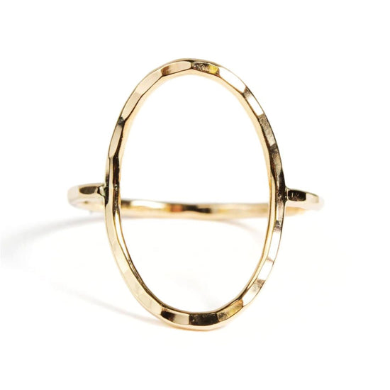 A gold ring with a unique oval shape.