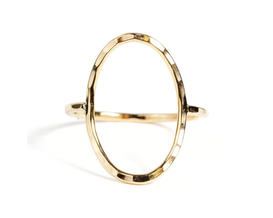 A gold ring with a unique oval shape.