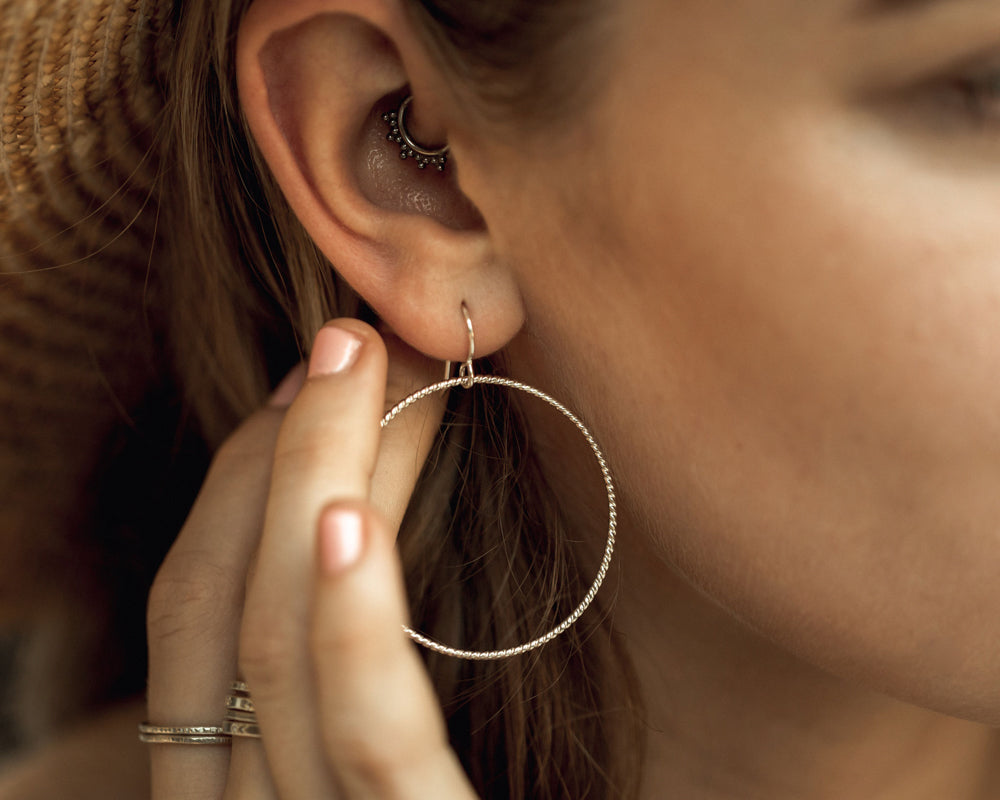 This lovely material glints and gleams from all angles. Its smooth beauty is ideal for hoop earrings. Two sizes and three fine metal options make it easy to find your perfect pair. Bring chic simplicity and elevated charm with these hoop earrings.