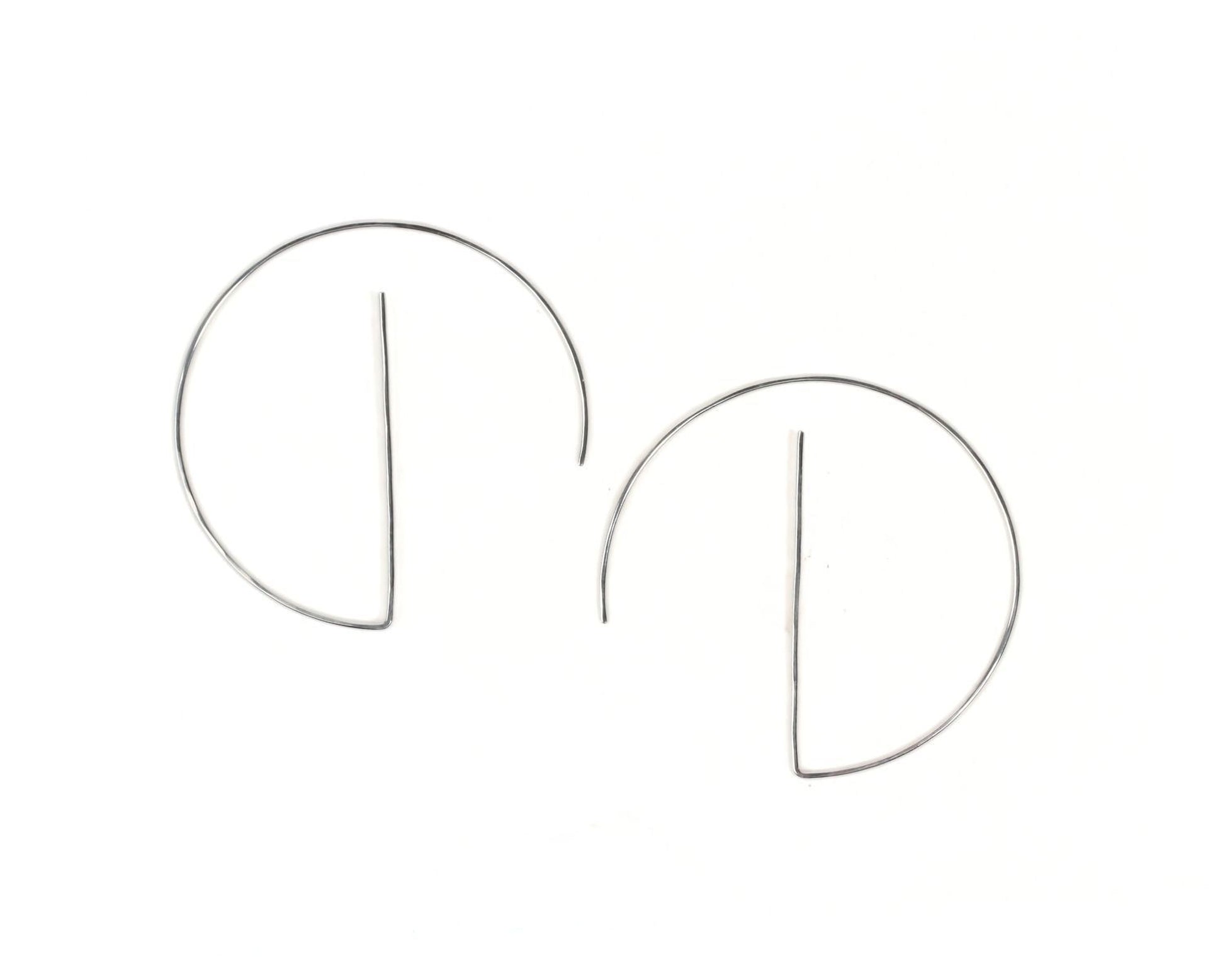 A pair of silver hoop earrings with a simple, minimalist design.