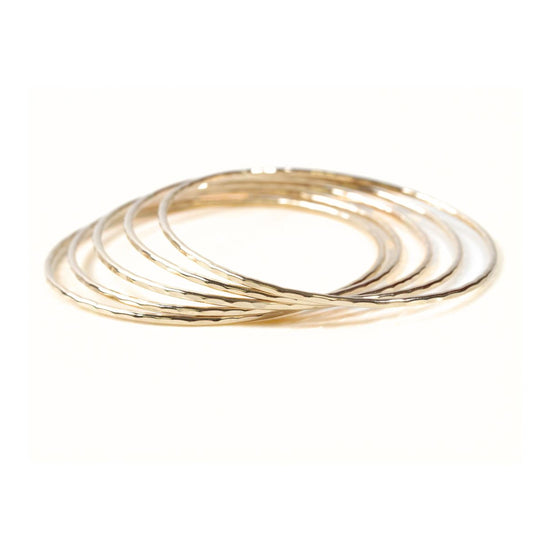 A group of gold-colored rings stacked together.