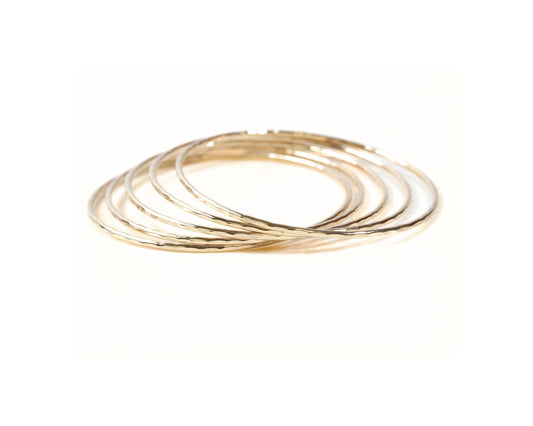 A group of gold-colored rings stacked together.