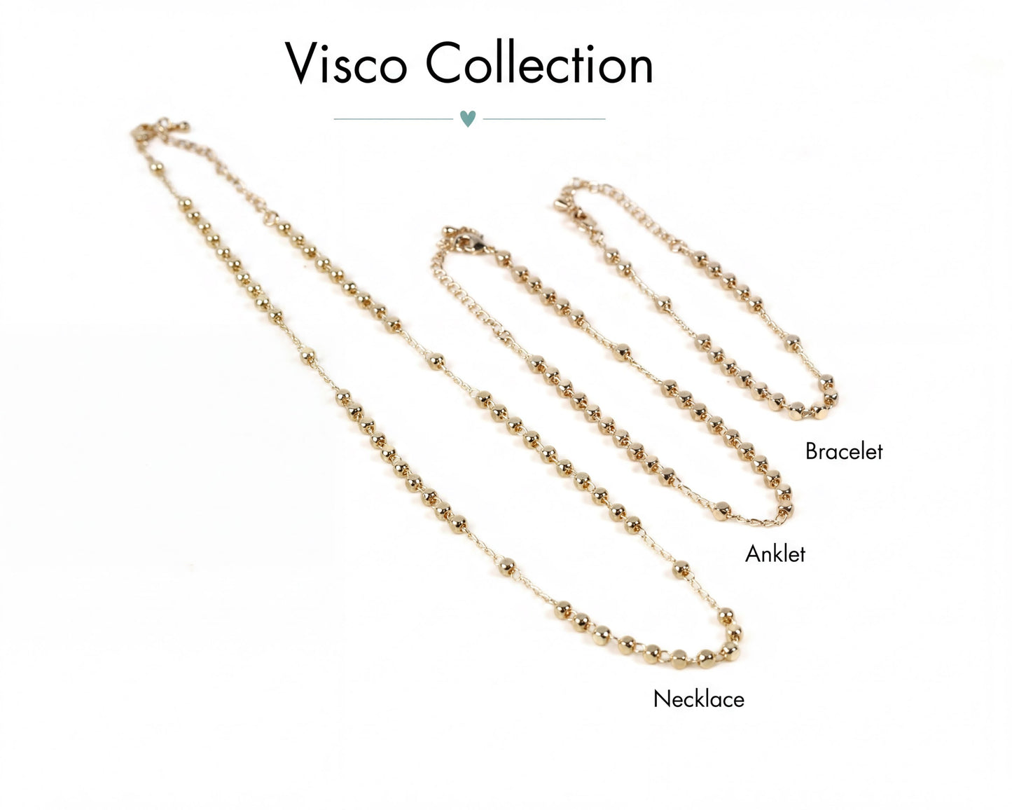 a collection of three gold-colored necklaces, each with a different length, arranged in a row.