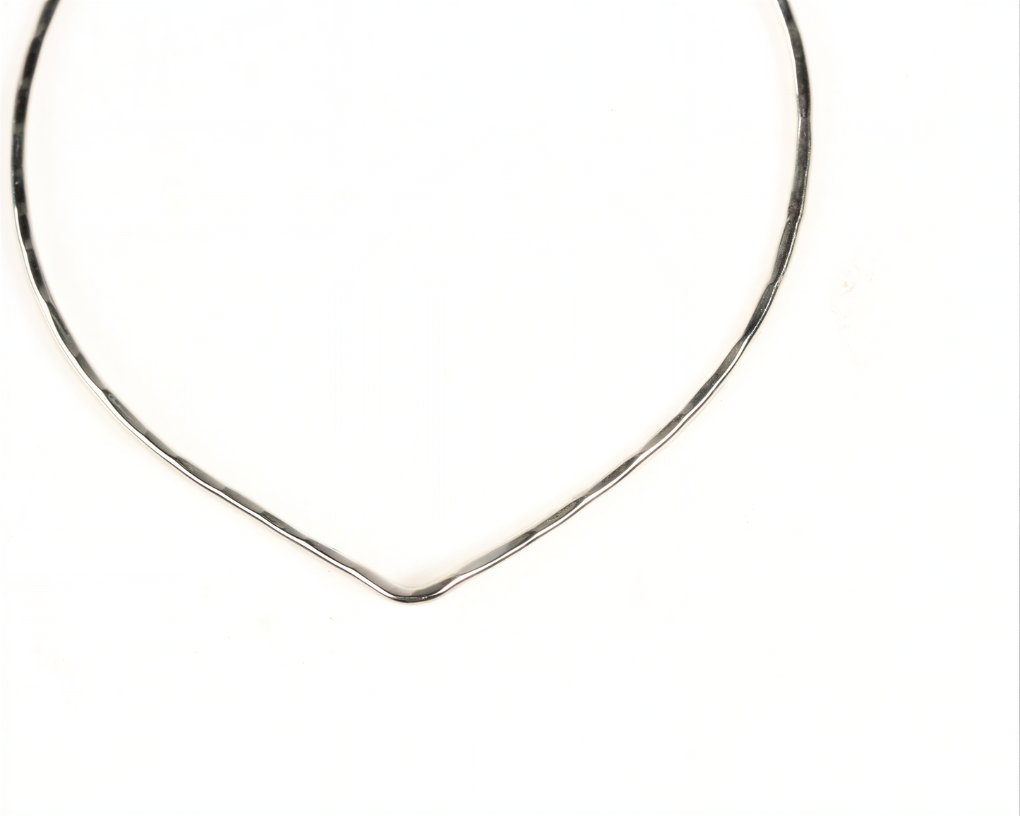 A simple silver necklace with a curved, metallic design.