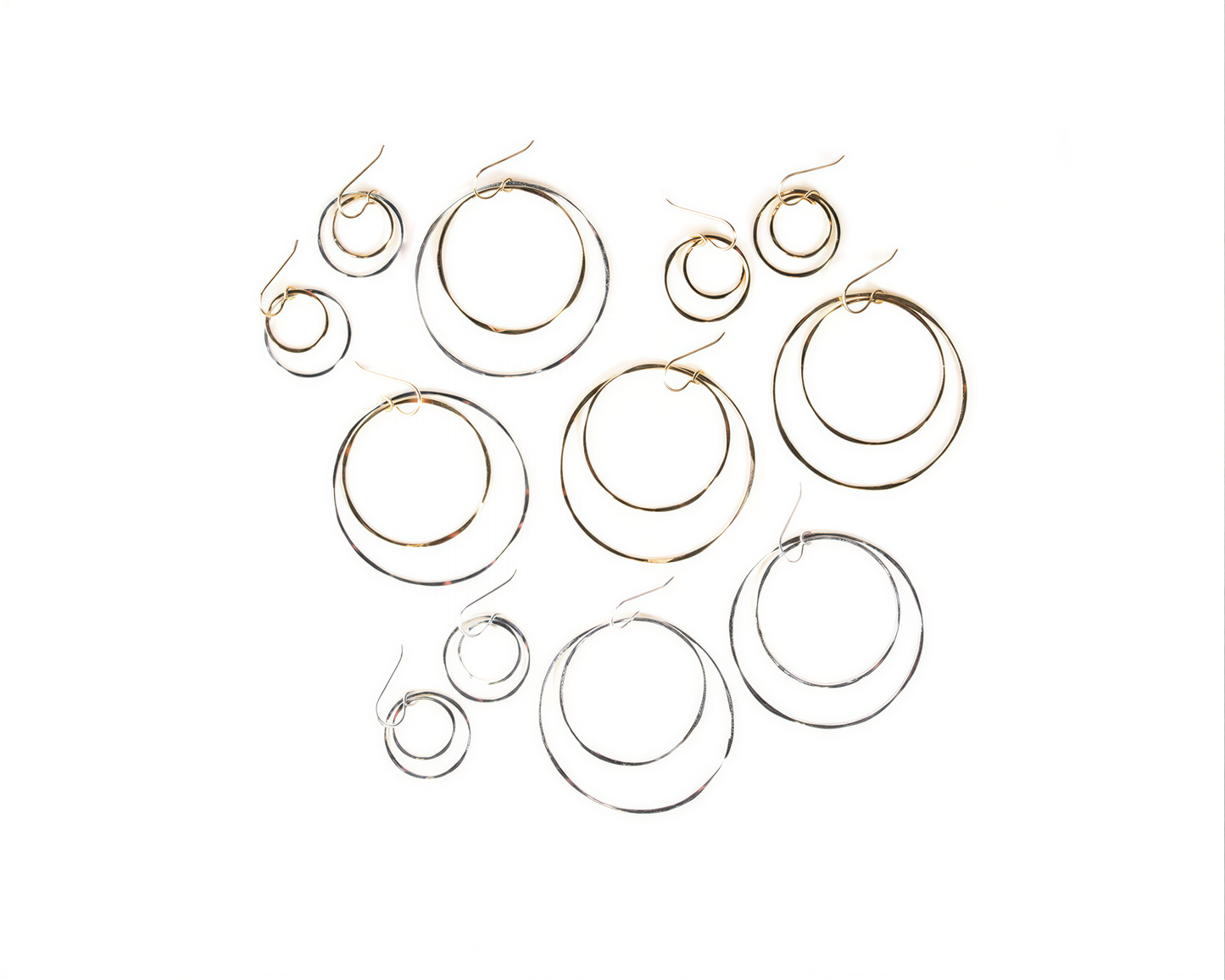 a collection of various hoop earrings, including some with multiple tiers and others with a single tier.