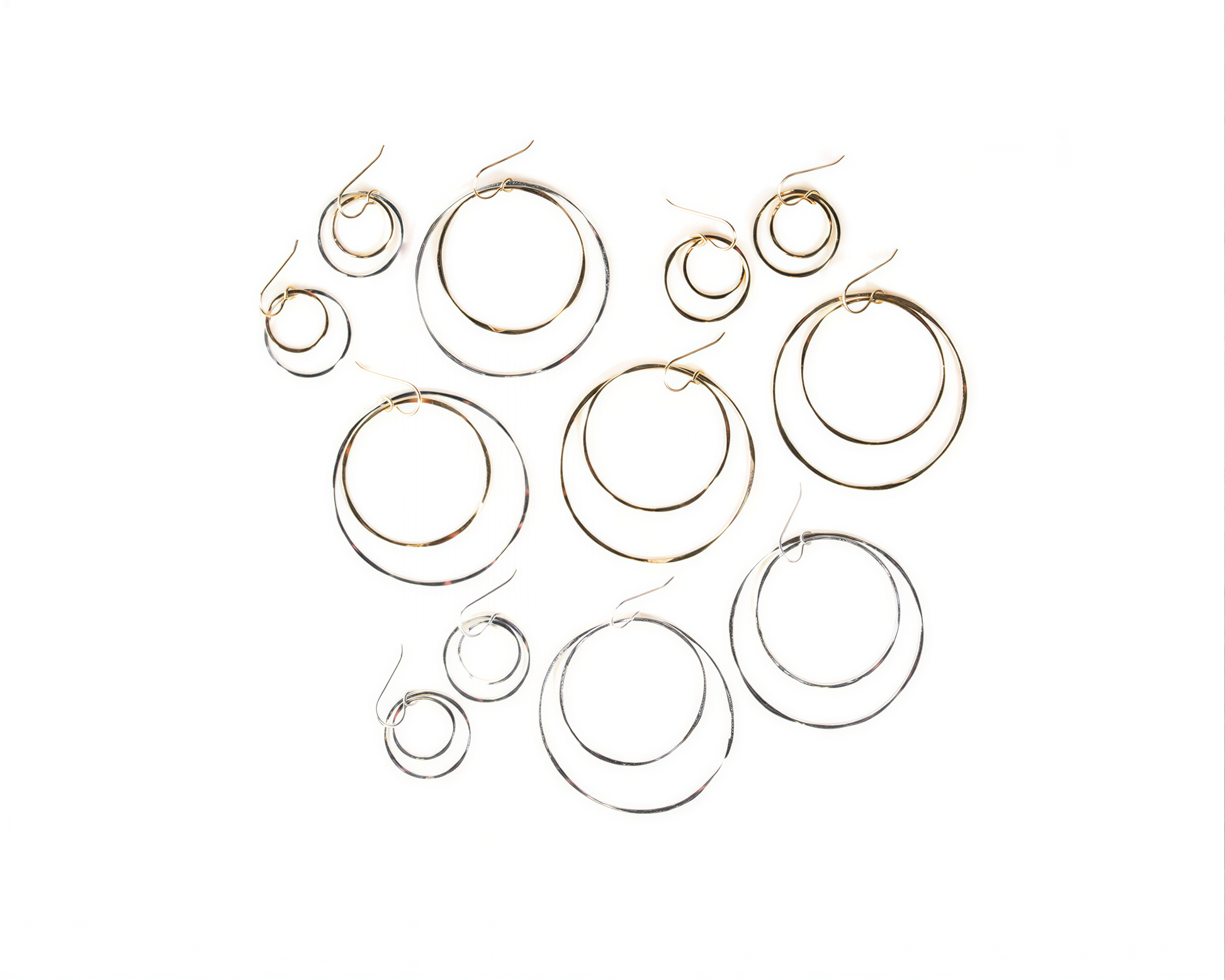 a collection of various hoop earrings, including some with multiple tiers and others with a single tier.