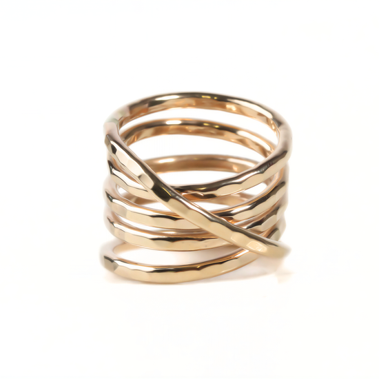 A gold ring with a twisted, coiled design.