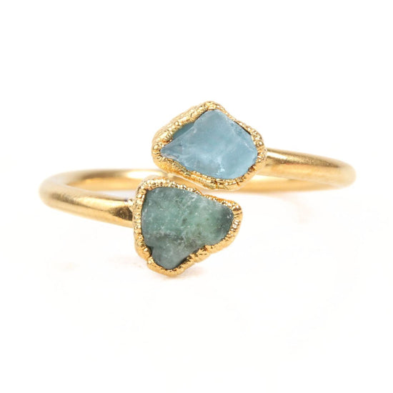 A gold ring with two blue gemstones set in it.