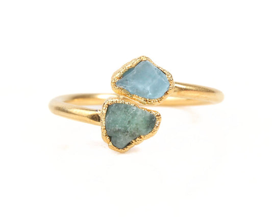 A gold ring with two blue gemstones set in it.