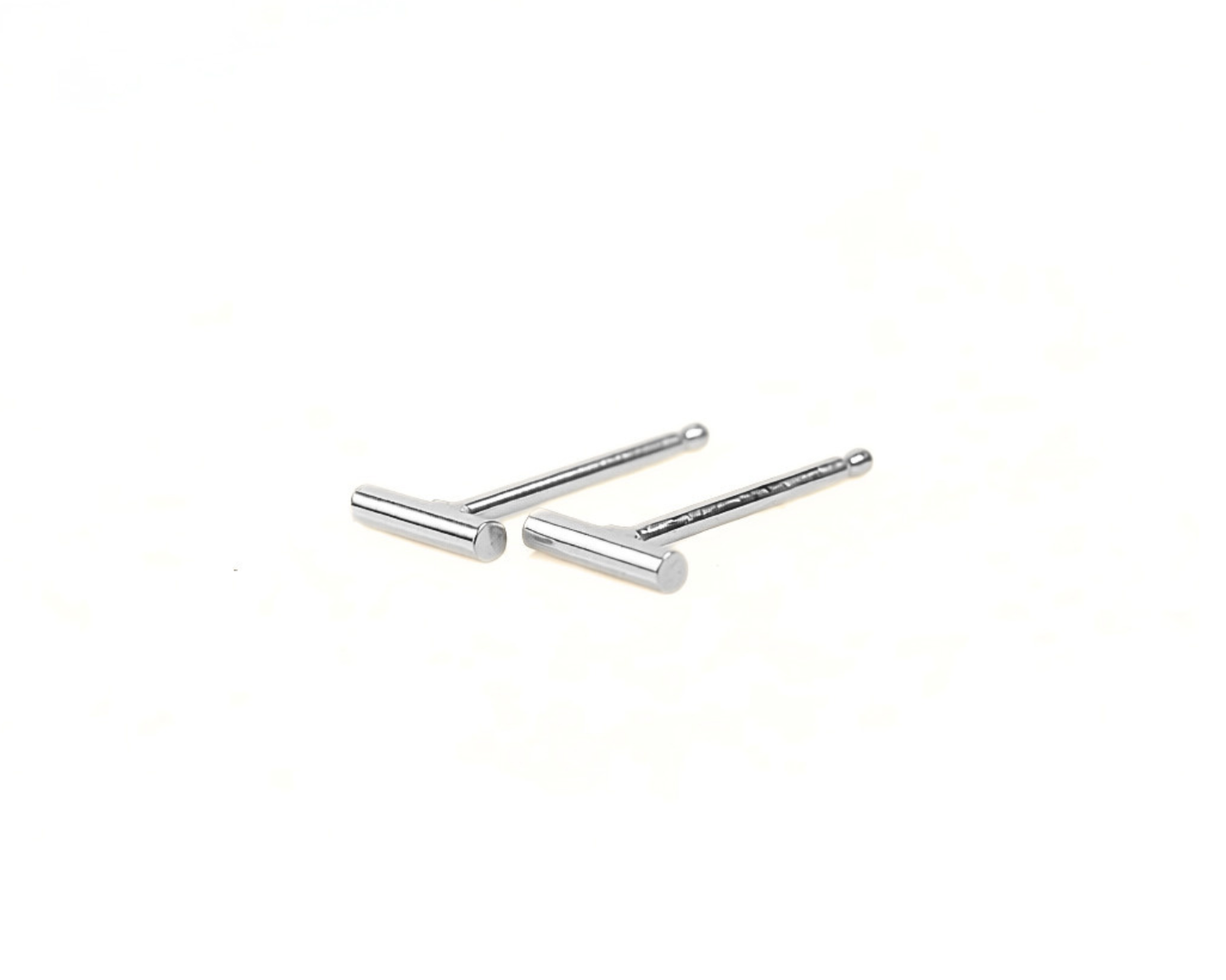 Two silver-colored earrings with a simple, minimalist design are shown against a plain white background.