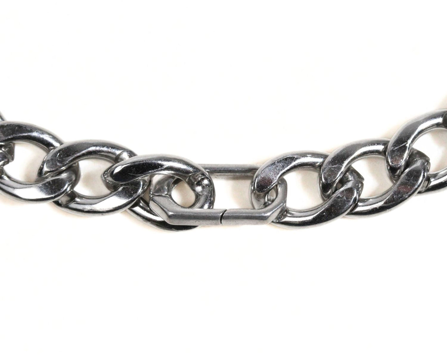 A close-up view of a silver-colored metal chain with a clasp, showing the intricate details of the links and the clasp mechanism.