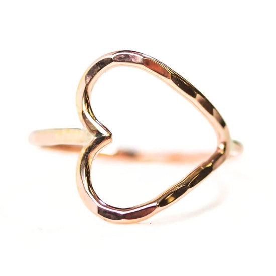 A gold-colored ring with a heart-shaped cutout in the center.