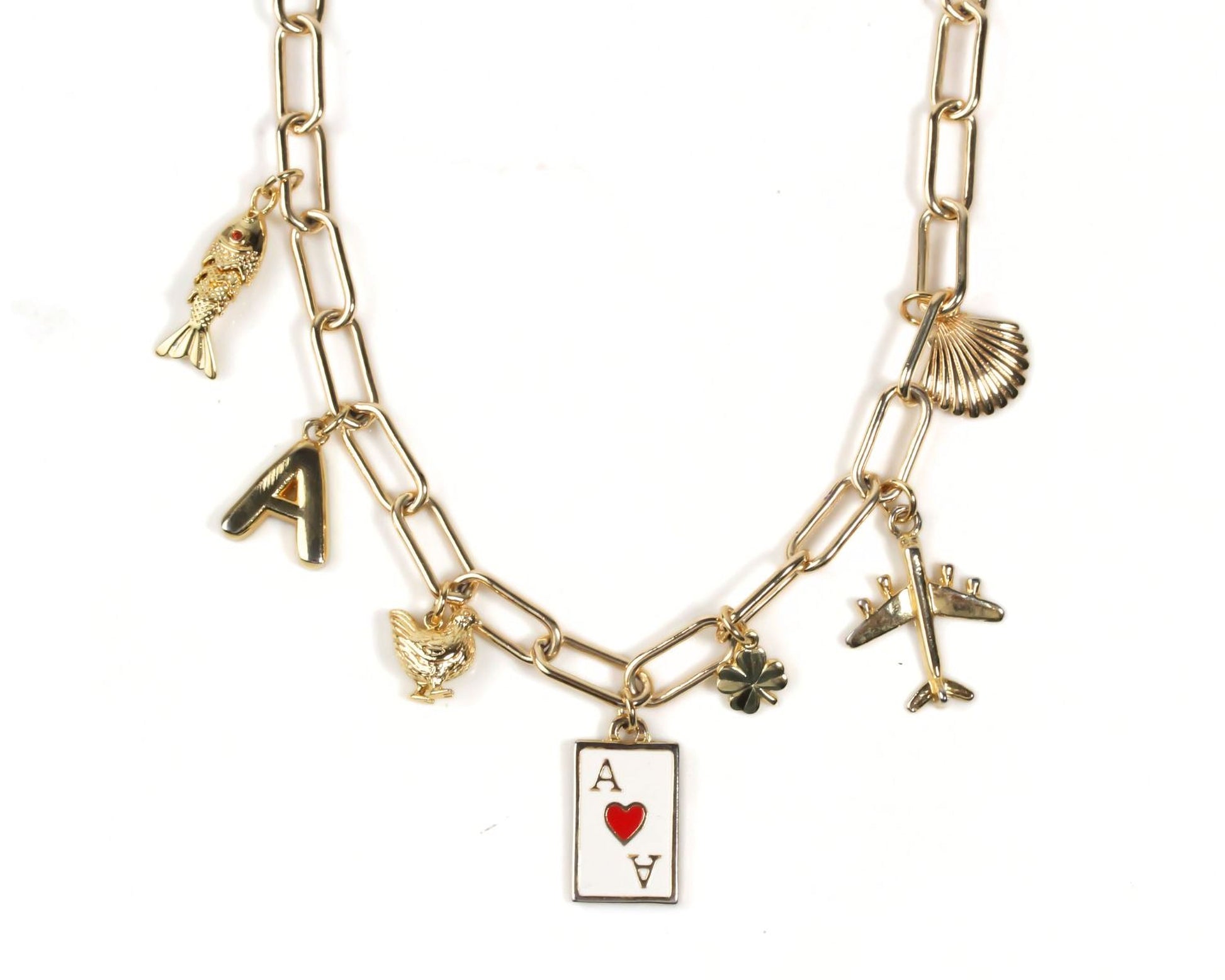 A gold-colored necklace with various charms, including a heart-shaped charm, a fish charm, and a shell charm.