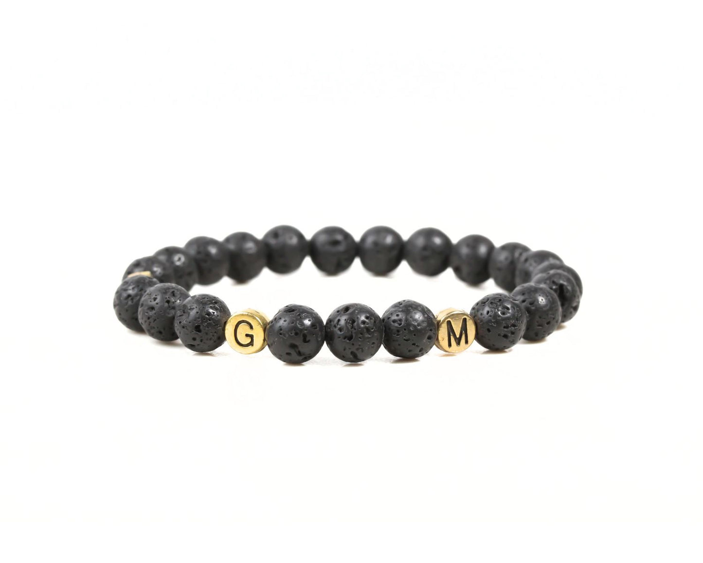A bracelet made of black beads with the letters 'G' and 'M' on them.