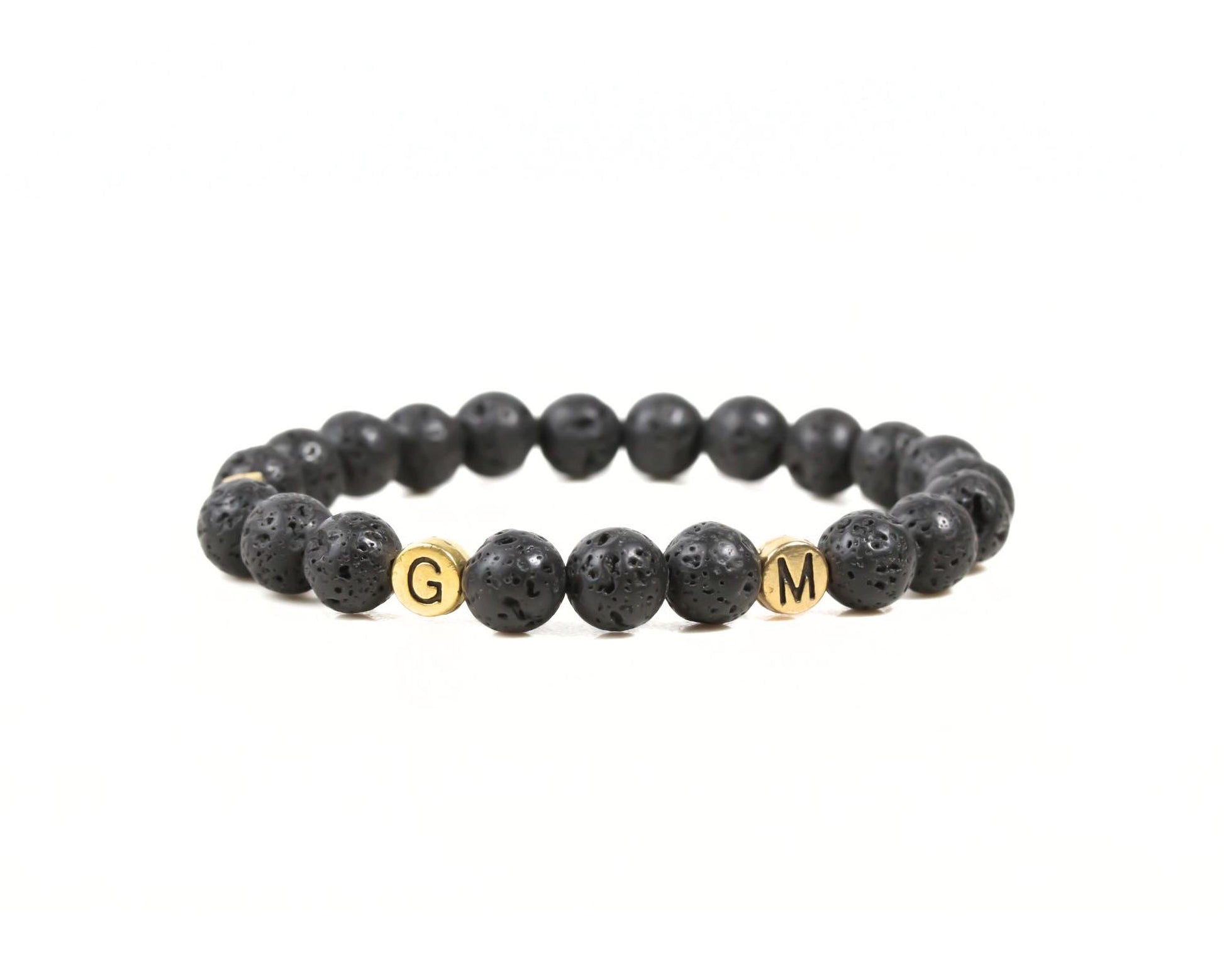A bracelet made of black beads with the letters 'G' and 'M' on them.