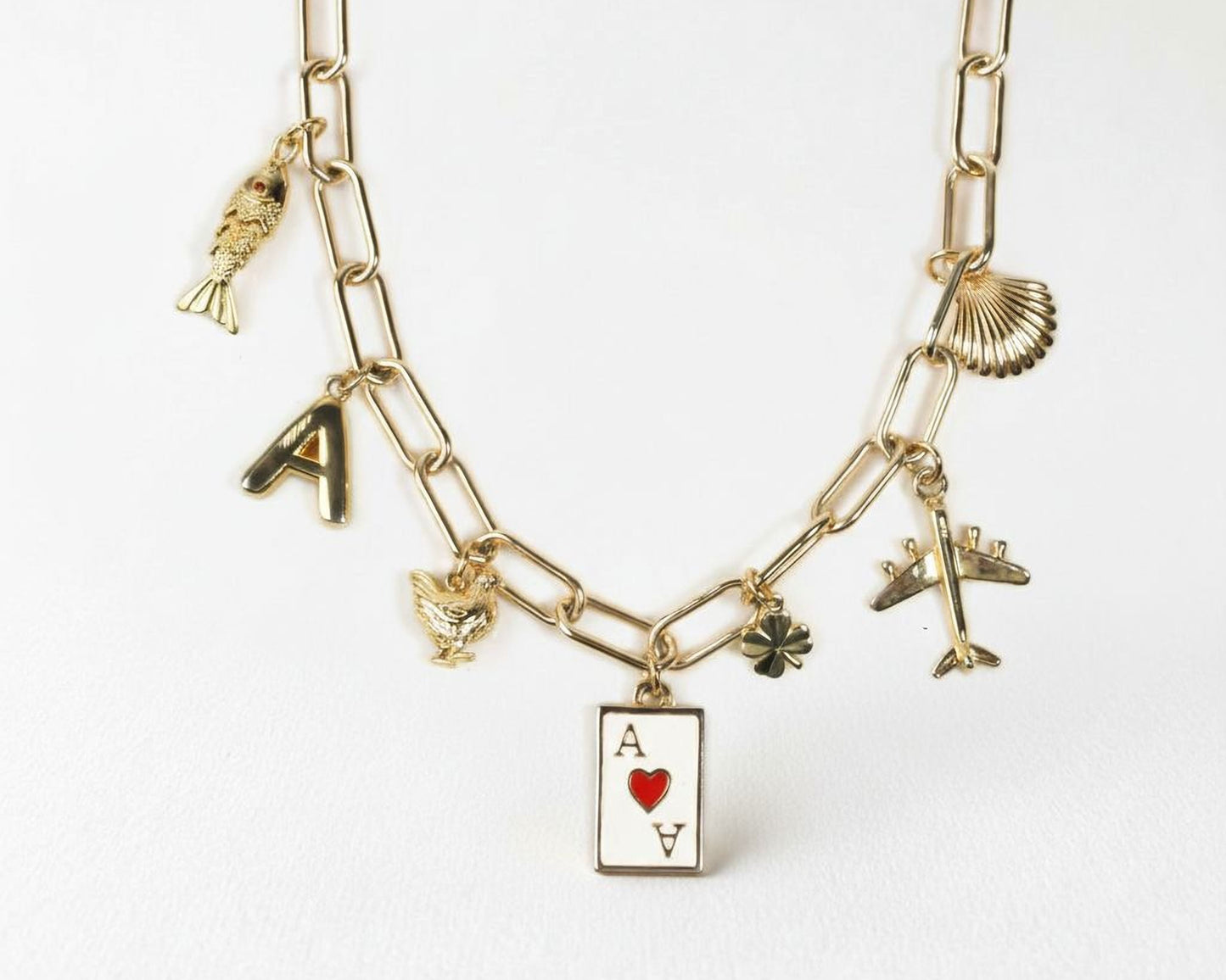 A gold-colored necklace with various charms and pendants attached to it.