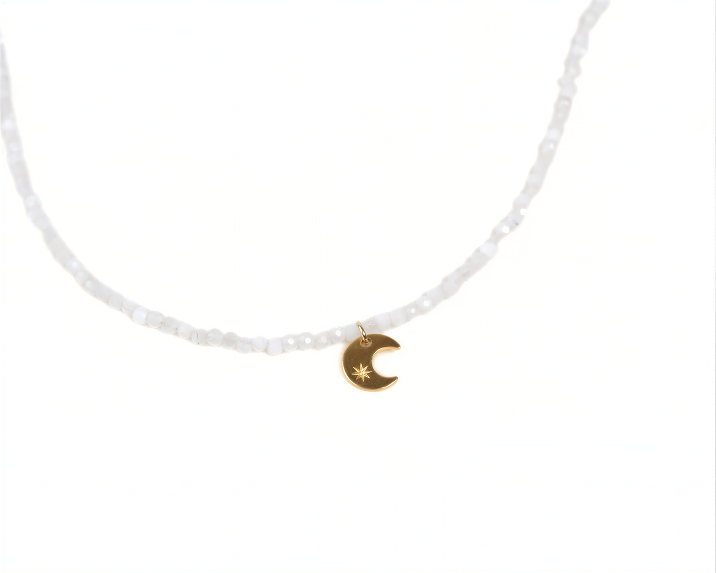 A necklace with a charm featuring a crescent moon and star symbol.