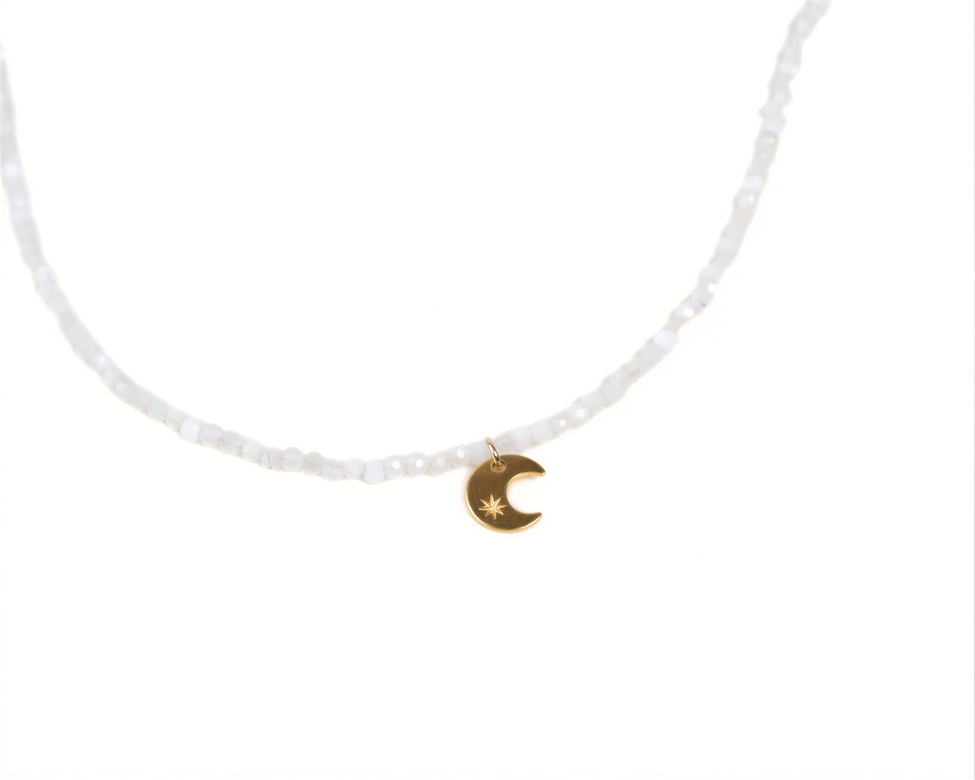A necklace with a charm featuring a crescent moon and star symbol.