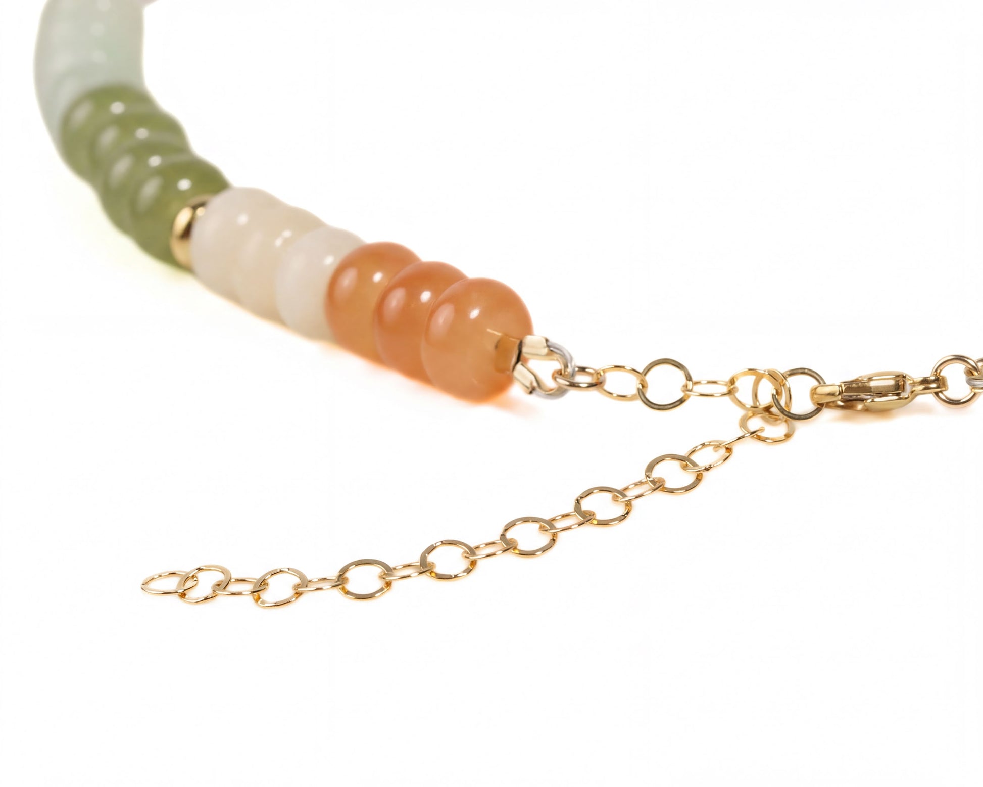 A necklace with a row of colorful beads, including green, white, orange, and brown beads, connected by a gold chain.
