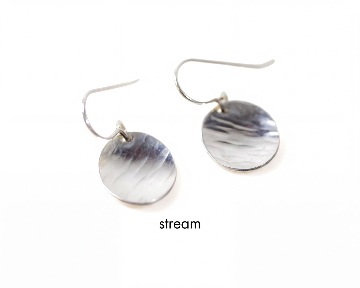 A pair of silver earrings with a smooth, shiny surface.