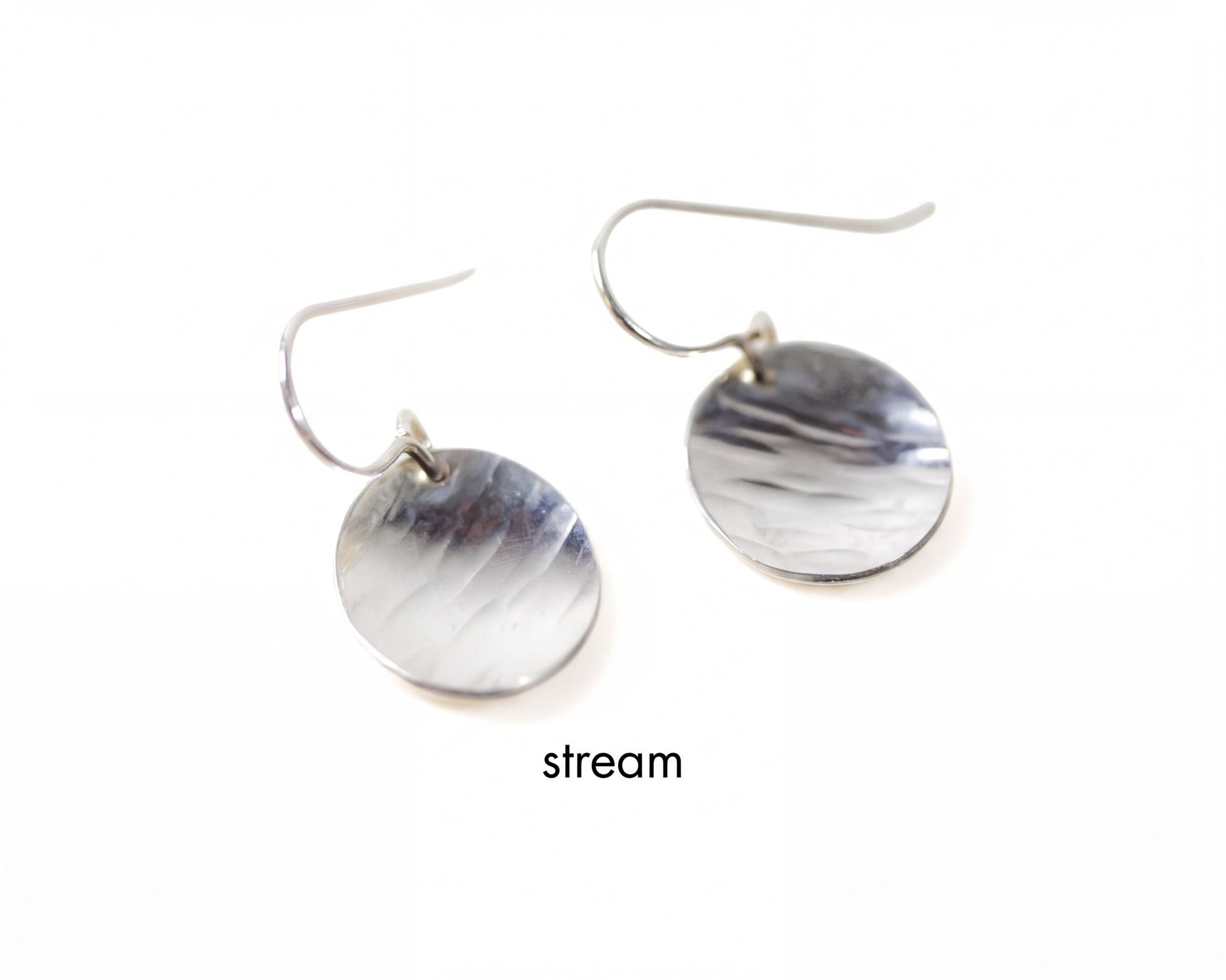A pair of silver earrings with a smooth, shiny surface.