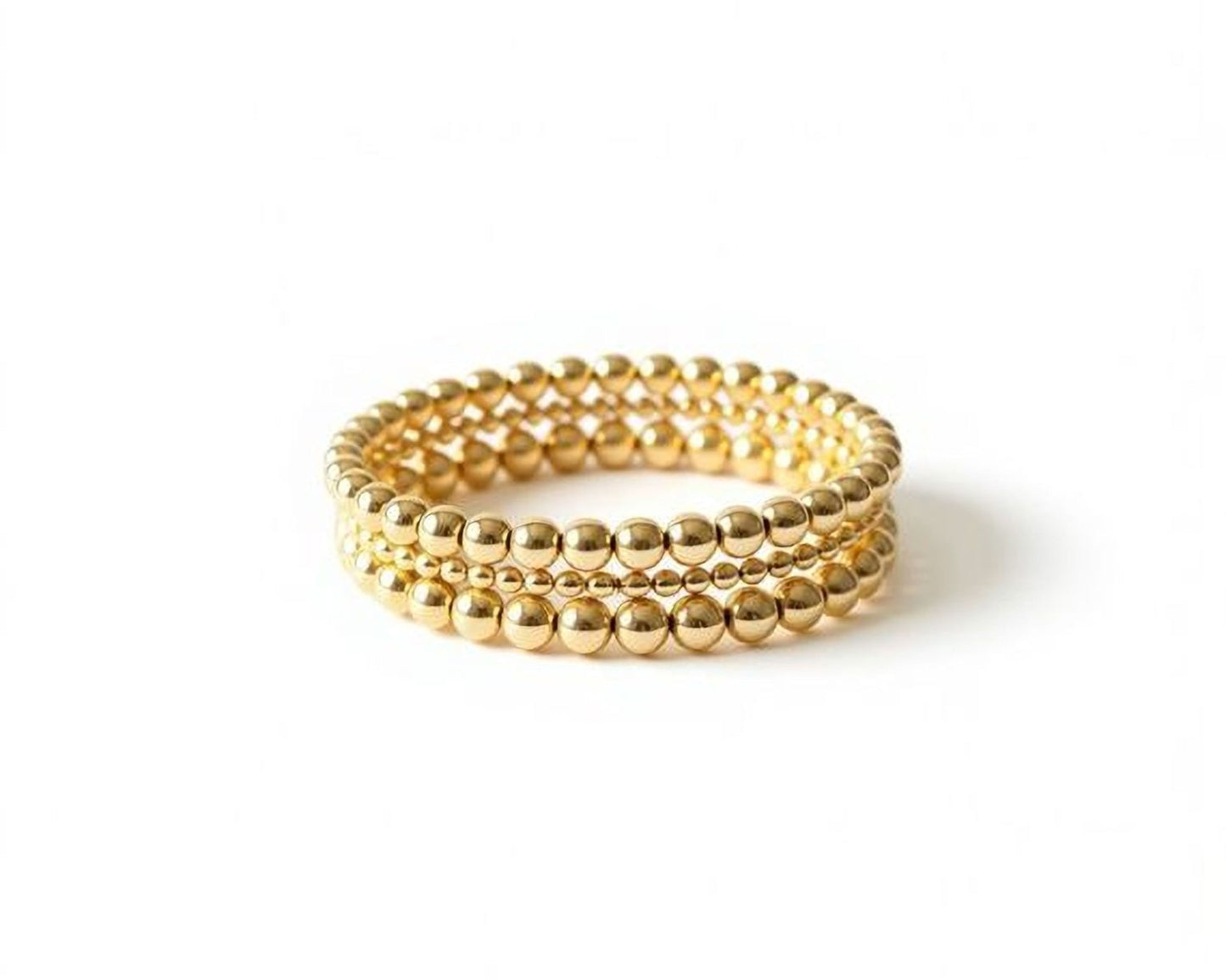 A gold-colored beaded bracelet with multiple rows of small, round beads.