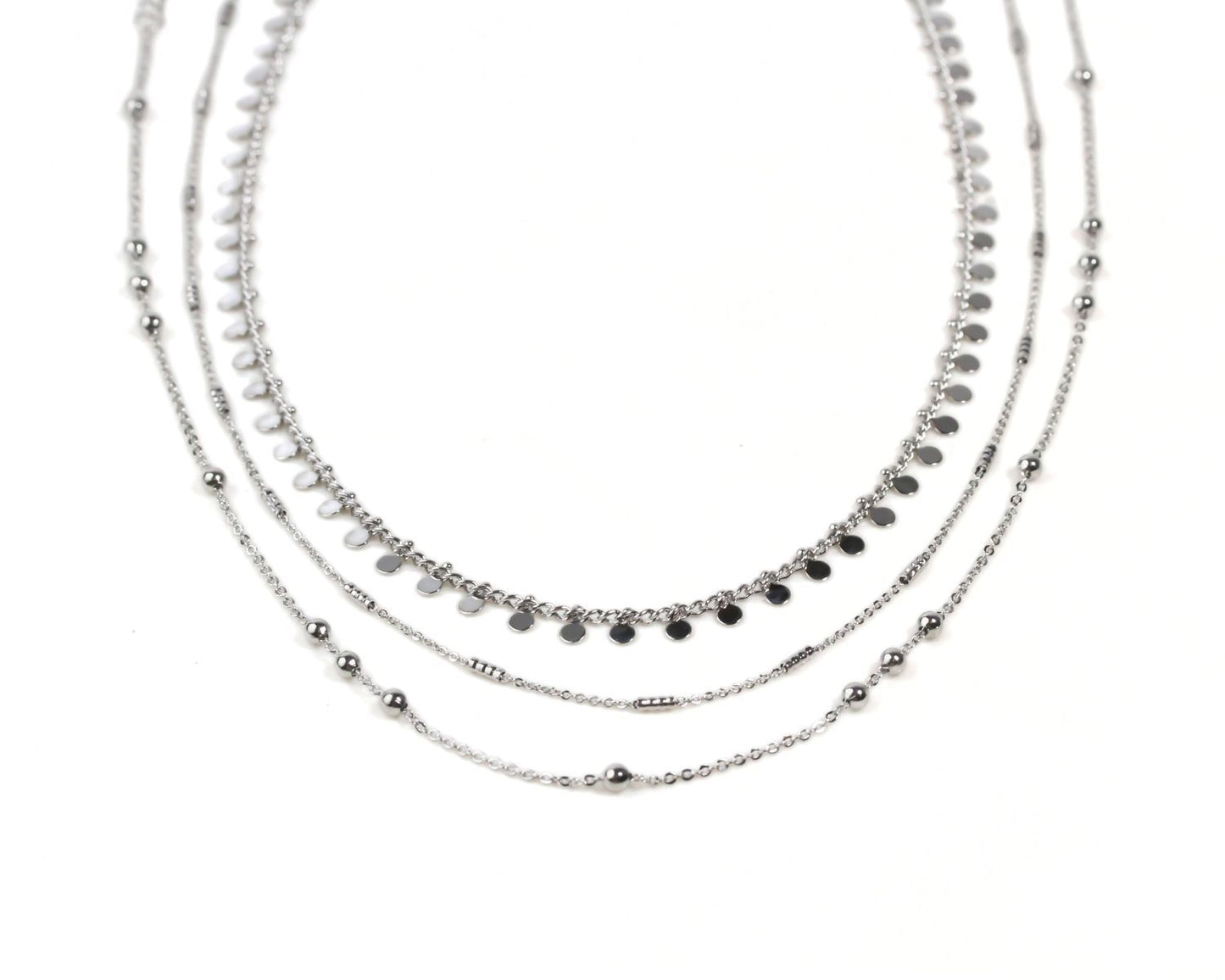 A silver necklace with multiple strands of beads and charms, creating a layered and intricate design.