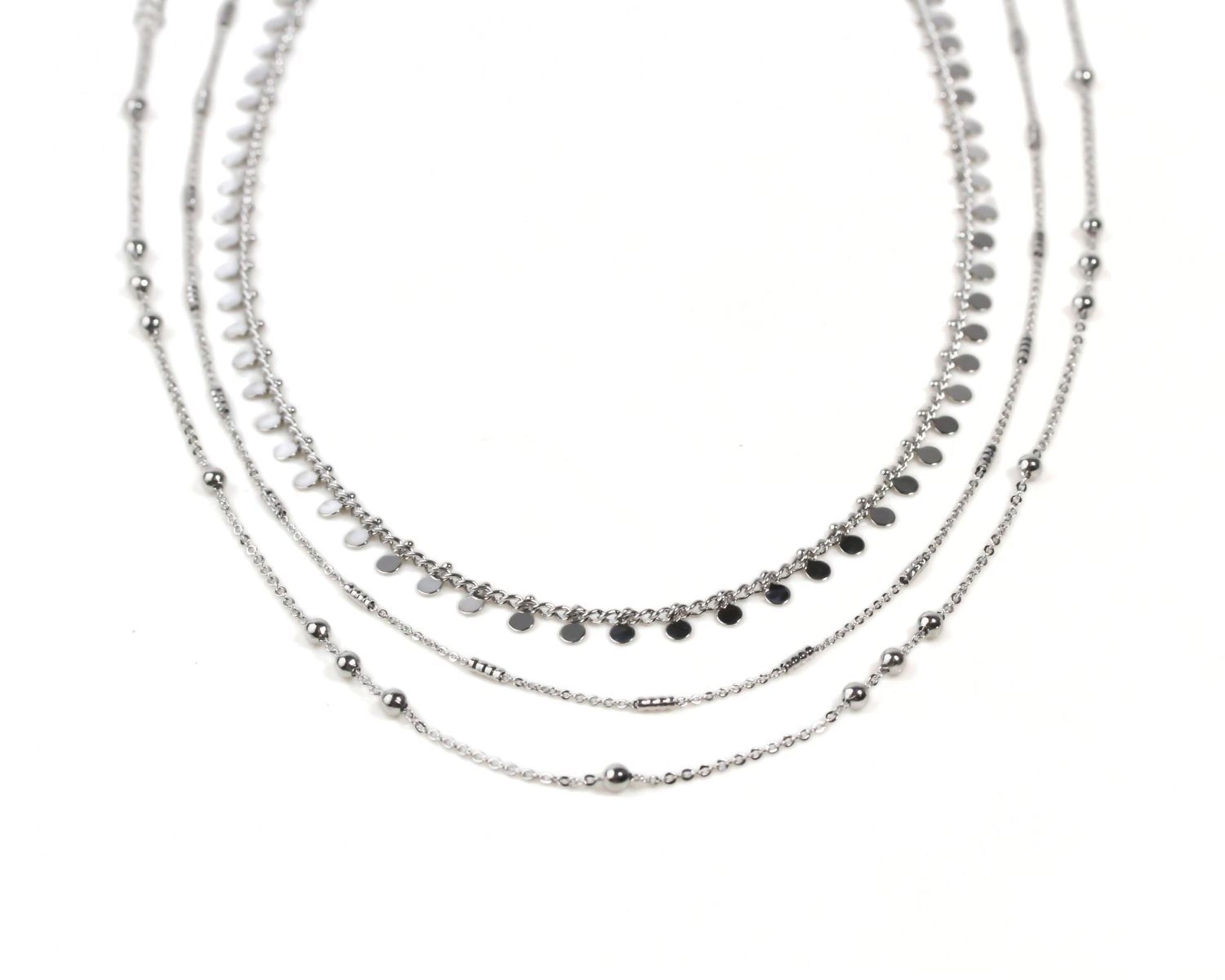 A silver necklace with multiple strands of beads and charms, creating a layered and intricate design.