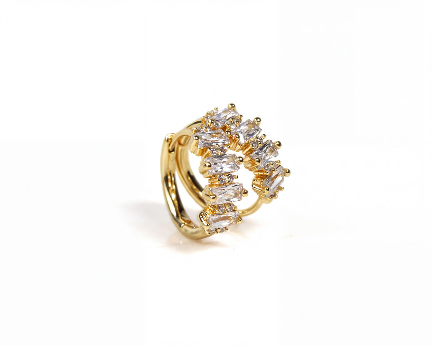 A gold earring with a decorative design of small, clear gemstones.