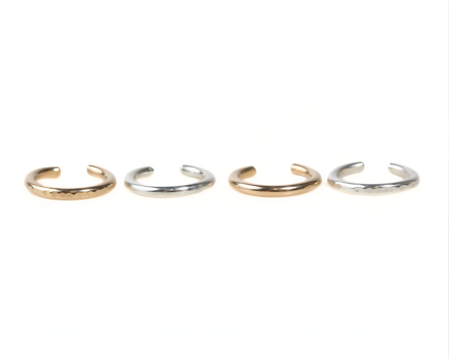 four rings of different colors and designs, arranged in a row.