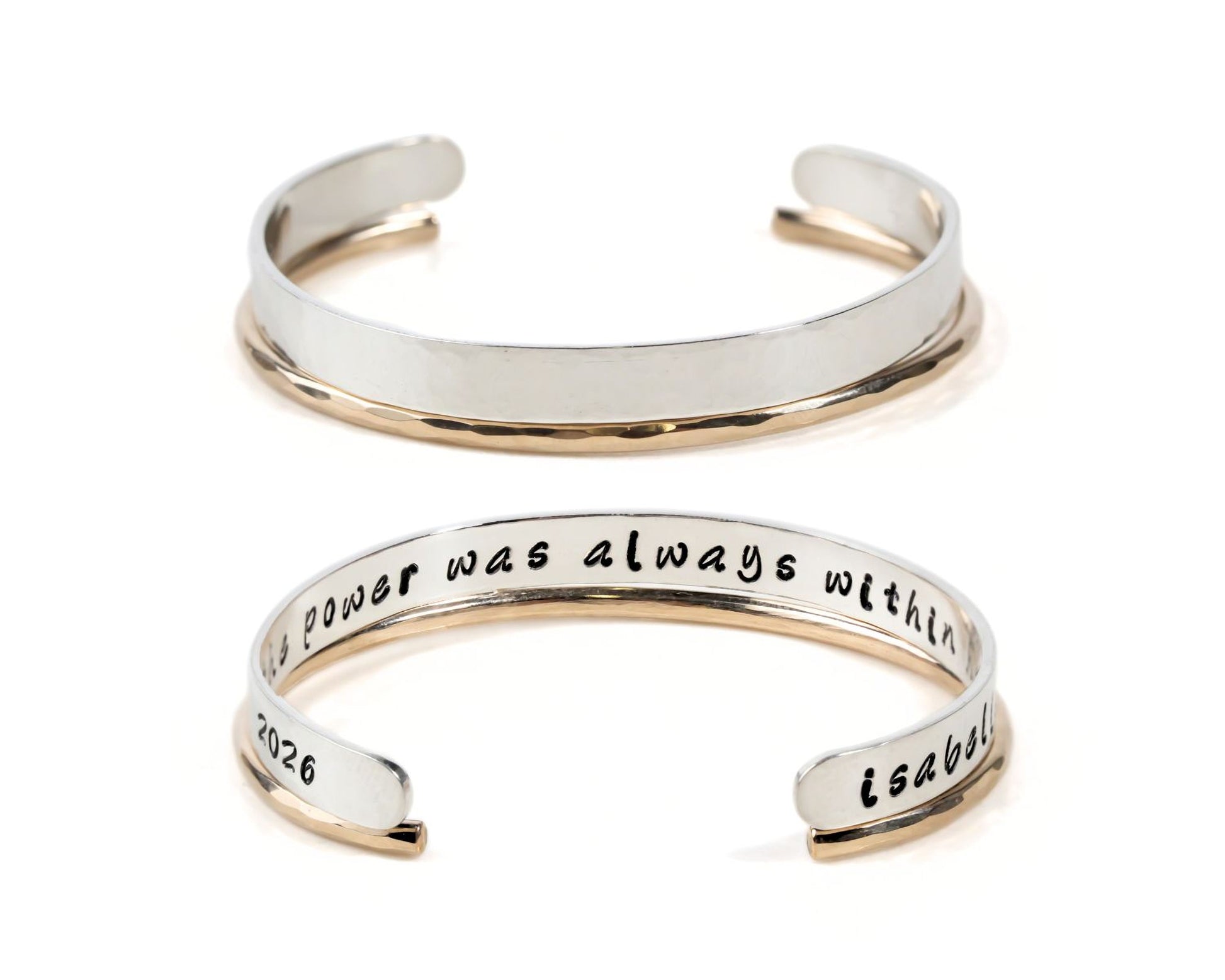 two silver bracelets with engraved text on them.