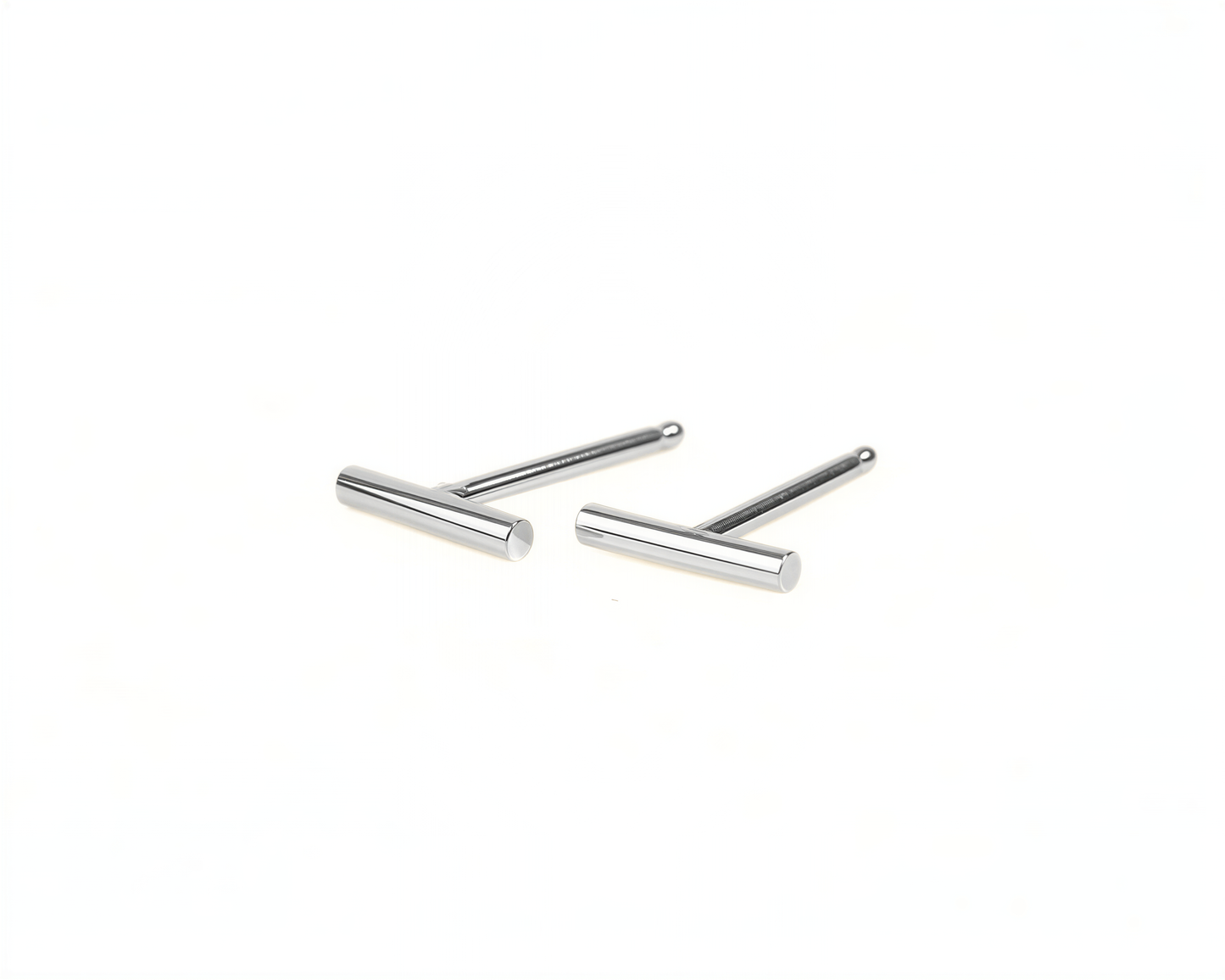 A pair of silver-colored earrings with a simple, minimalist design.