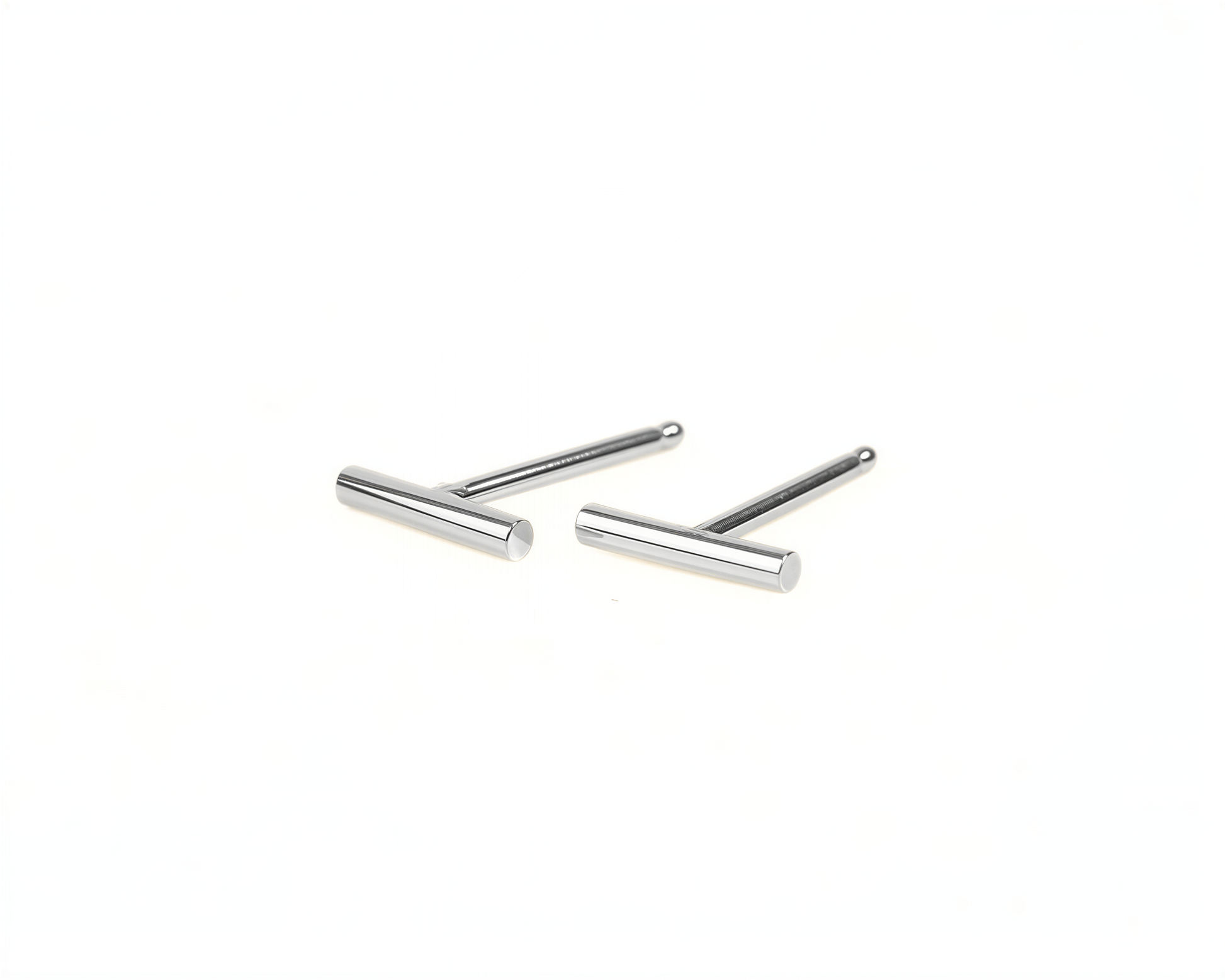 A pair of silver-colored earrings with a simple, minimalist design.